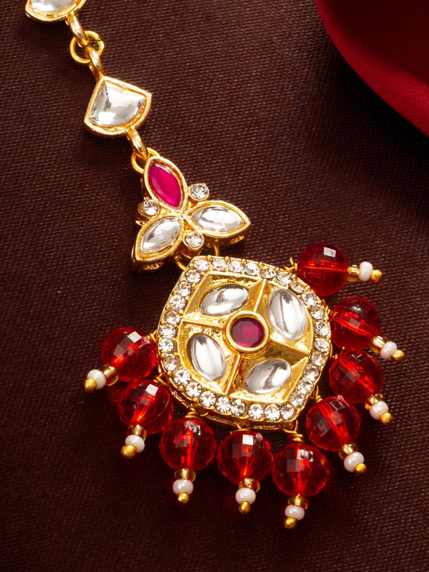 Aadita Gold Plated Half-Moon Kundan Chain Mangtika with Hexagonal Pendant and Red Bead Fringe