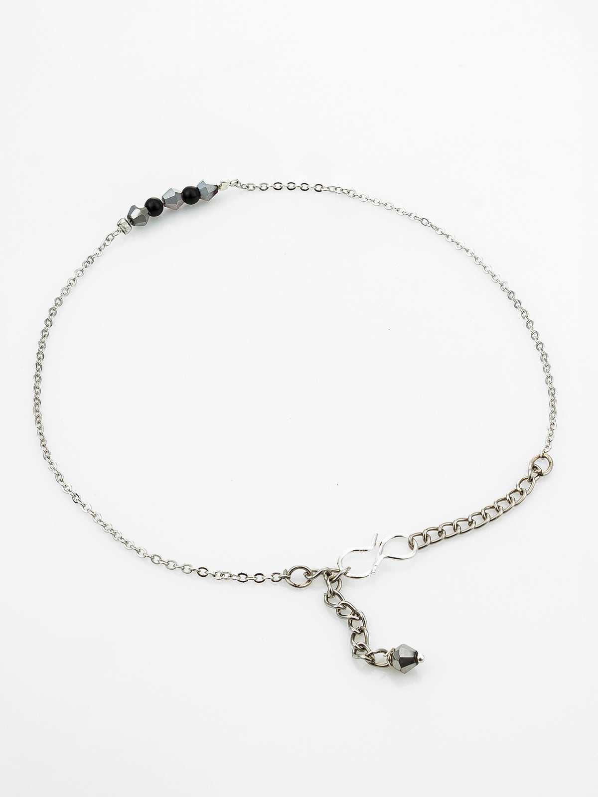 A delicate silver chain anklet with a beaded section, an infinity charm, and a dangling chain with a small bead, displayed on a clean white background.
