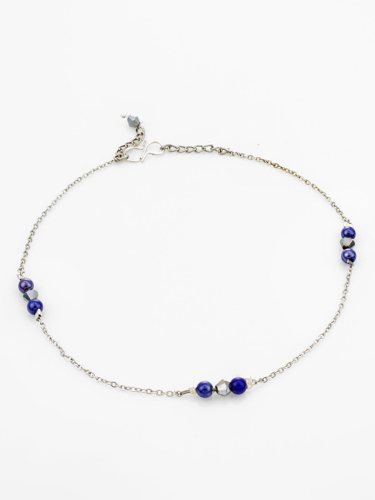 A delicate silver chain anklet featuring three clusters of deep blue beads and small silver spacer beads, displayed on a clean white background.