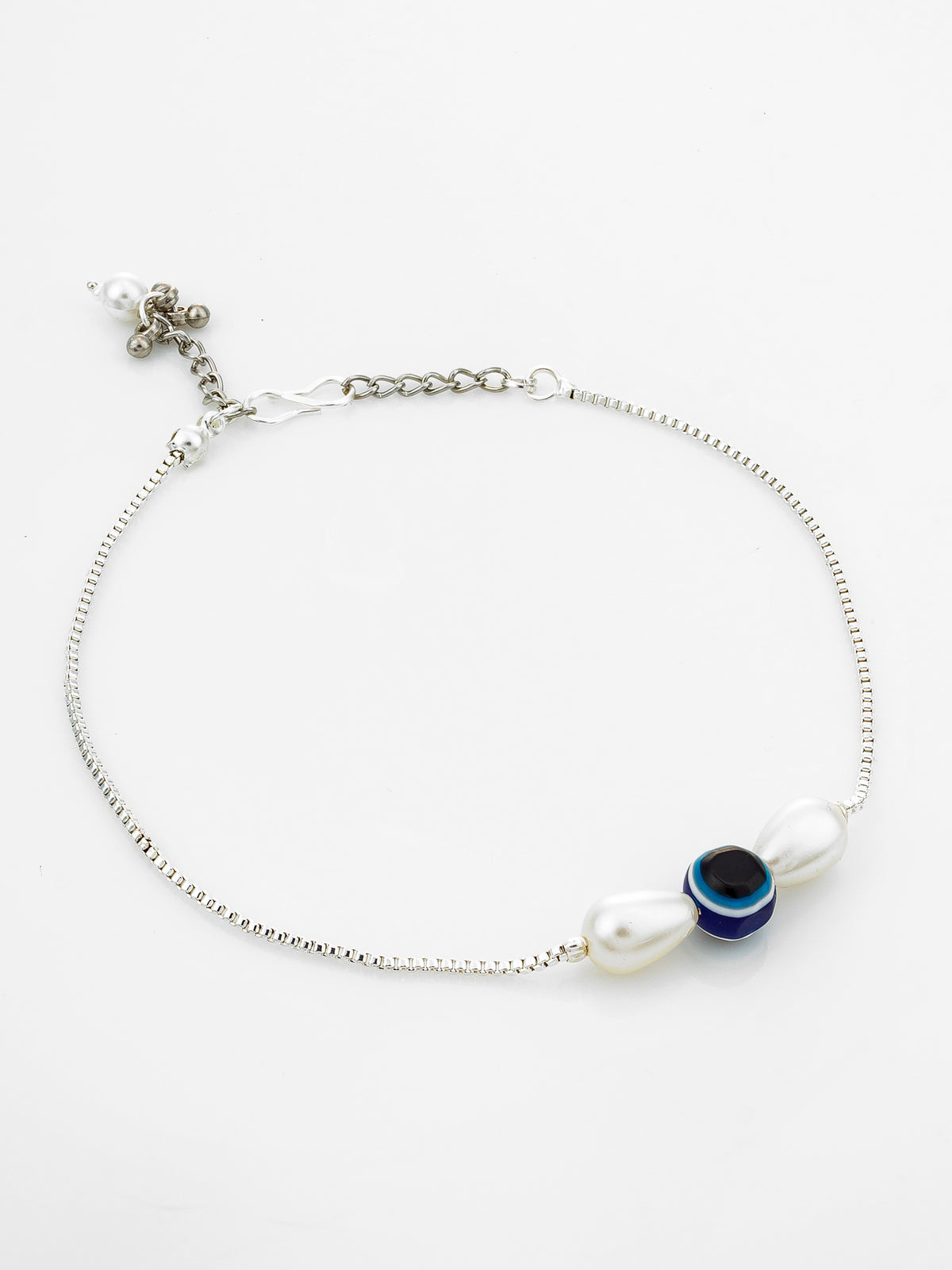 A silver chain anklet featuring a decorative charm with a white pearl, a blue and black evil eye bead, and a white bead, displayed on a clean white background.