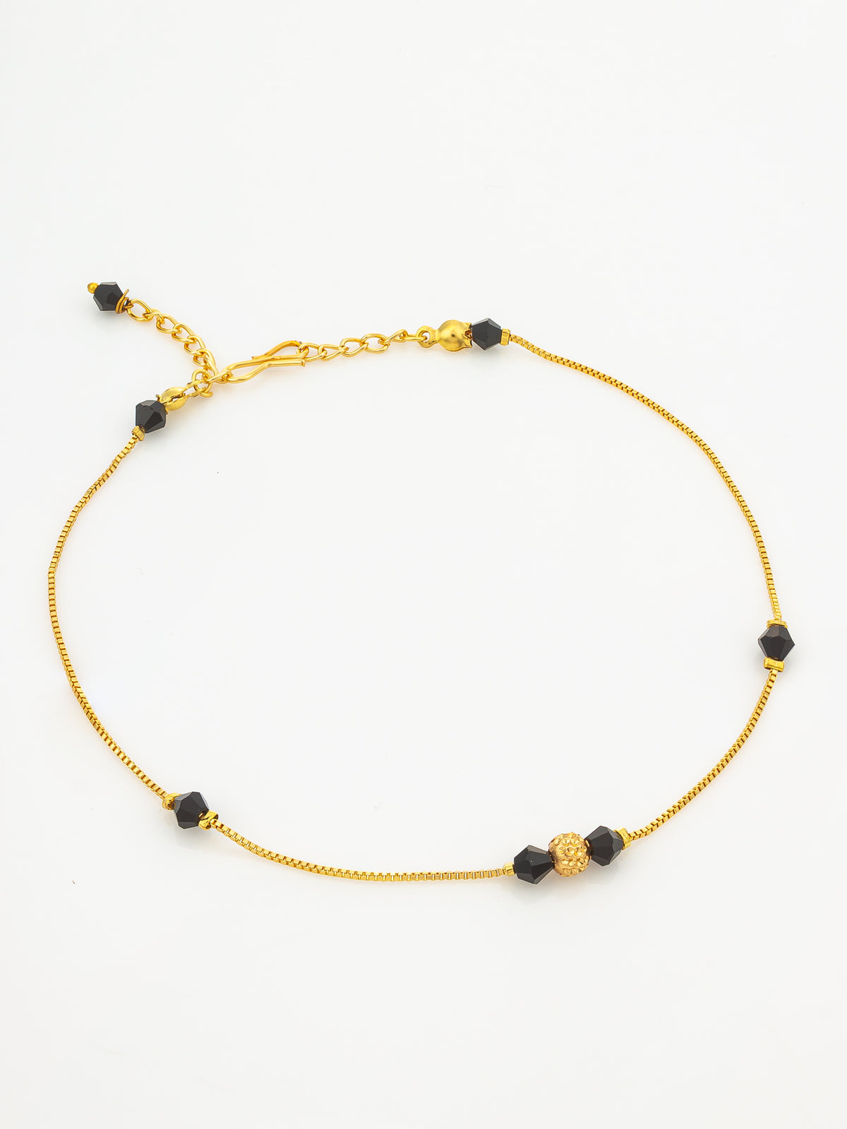 A delicate gold chain necklace with small black faceted beads and a textured gold accent bead, displayed on a clean white background.