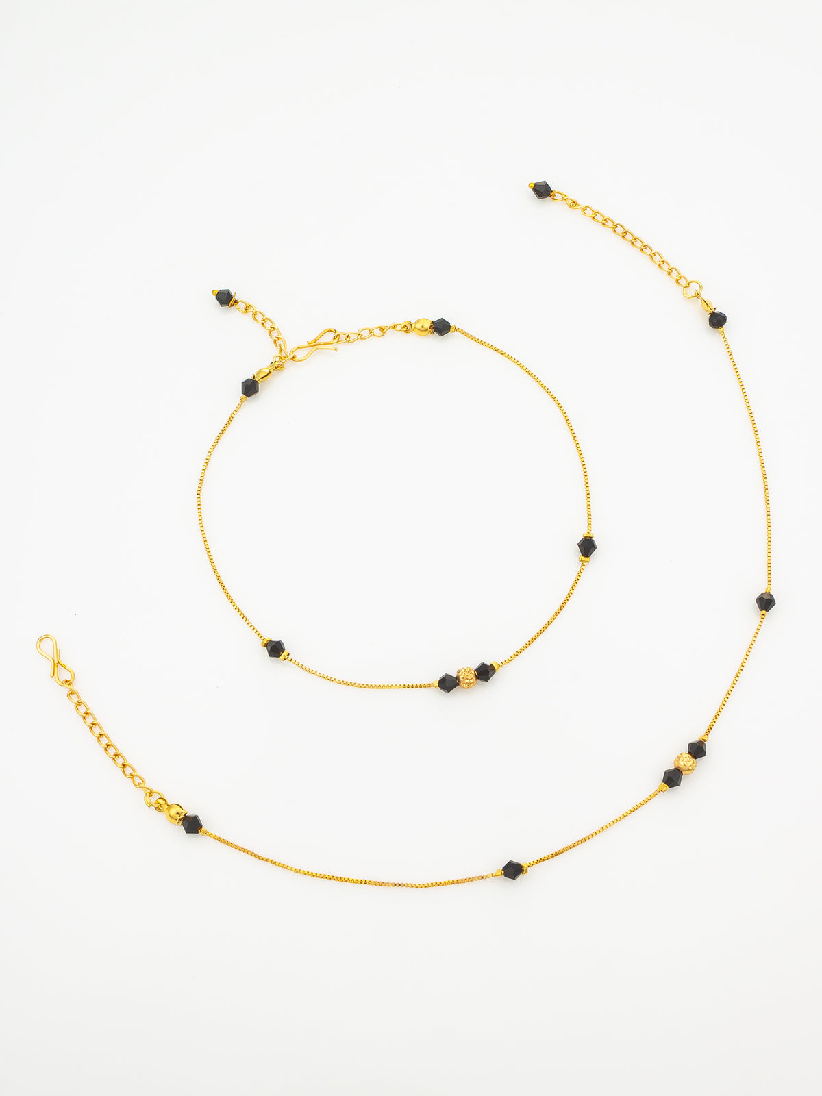 A delicate gold chain necklace with small black beads spaced along the length, displayed on a clean white background.