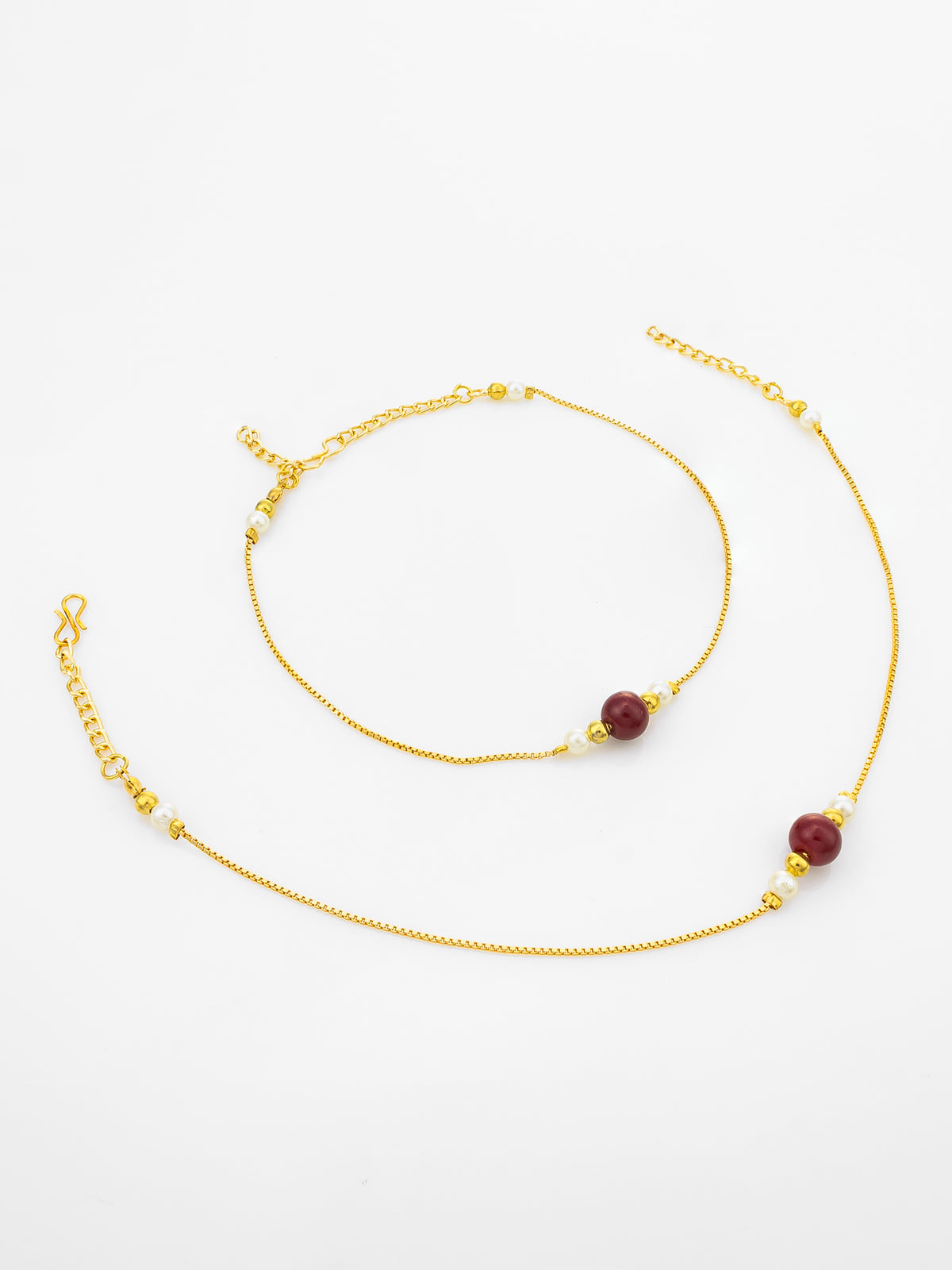 A delicate gold chain anklet featuring three round dark red beads, displayed on a clean white background.