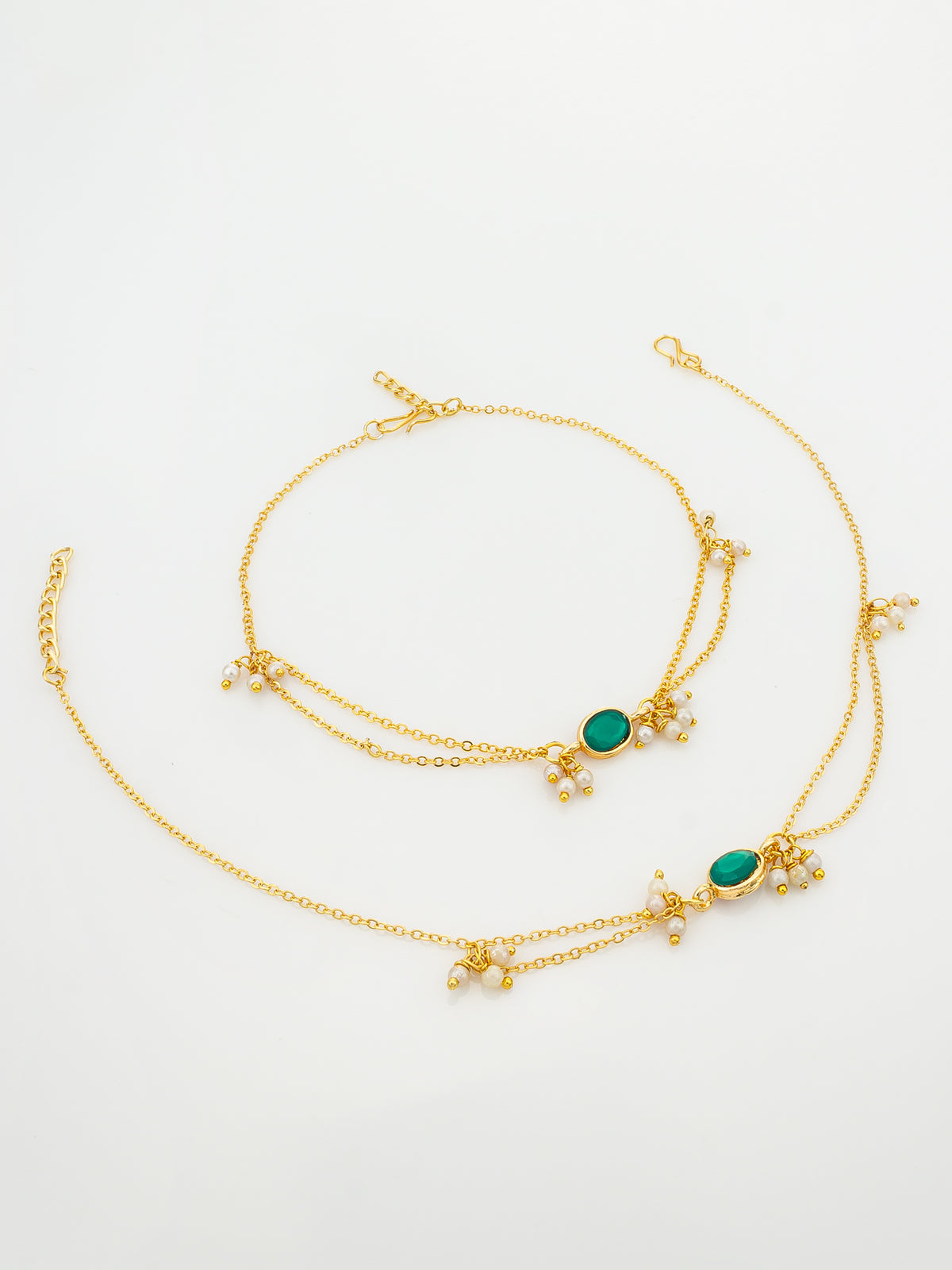 A gold-toned double-layered chain necklace with small floral clusters and oval green stone accents, displayed on a clean white background.