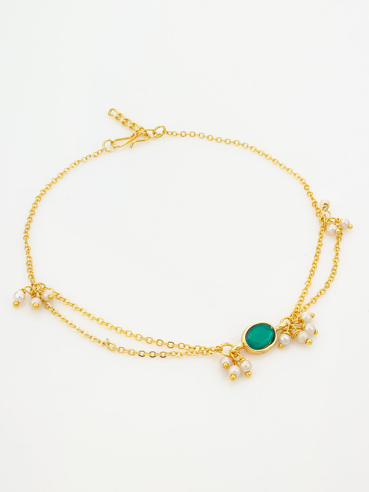 A gold double-strand anklet featuring a central oval green stone and small dangling pearl-like beads, displayed on a clean white background.