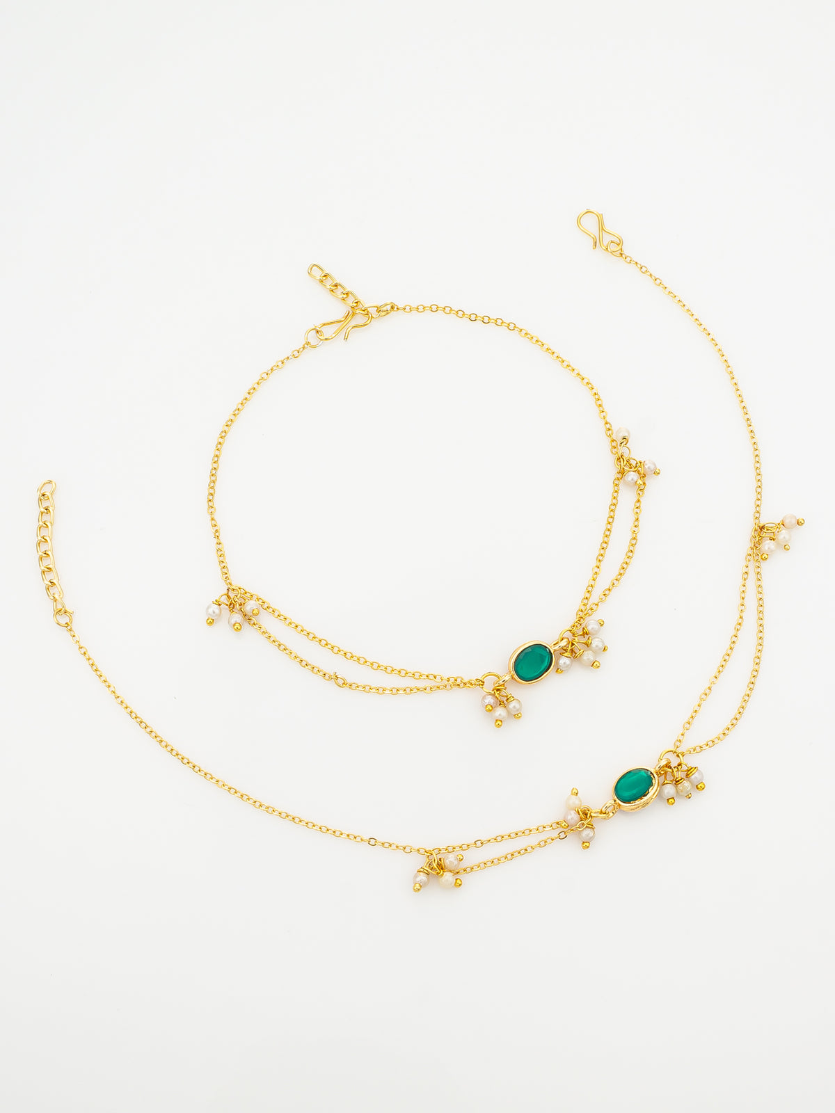 A gold-toned double-layered chain anklet featuring two oval green stone centers and small white pearl-like floral clusters, displayed on a clean white background.