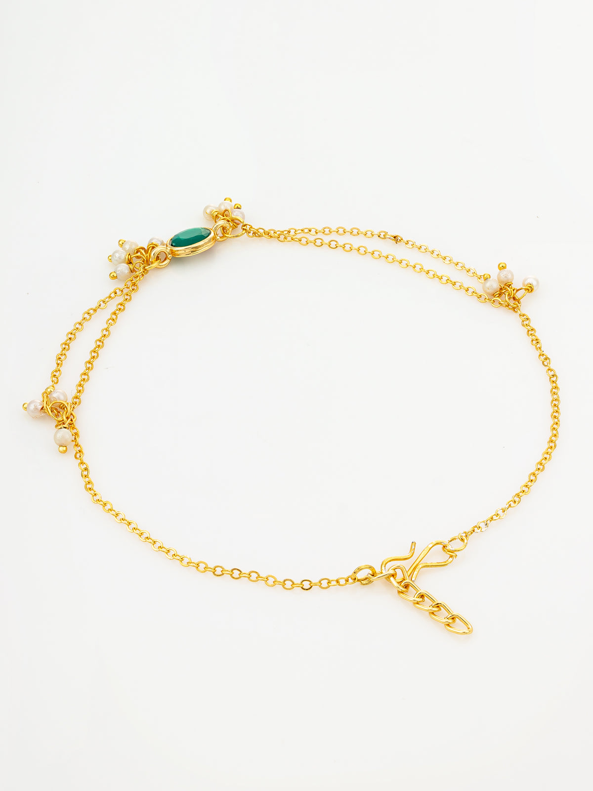 A delicate gold chain anklet with a small green oval stone and tiny white pearl-like accents, displayed on a clean white background.