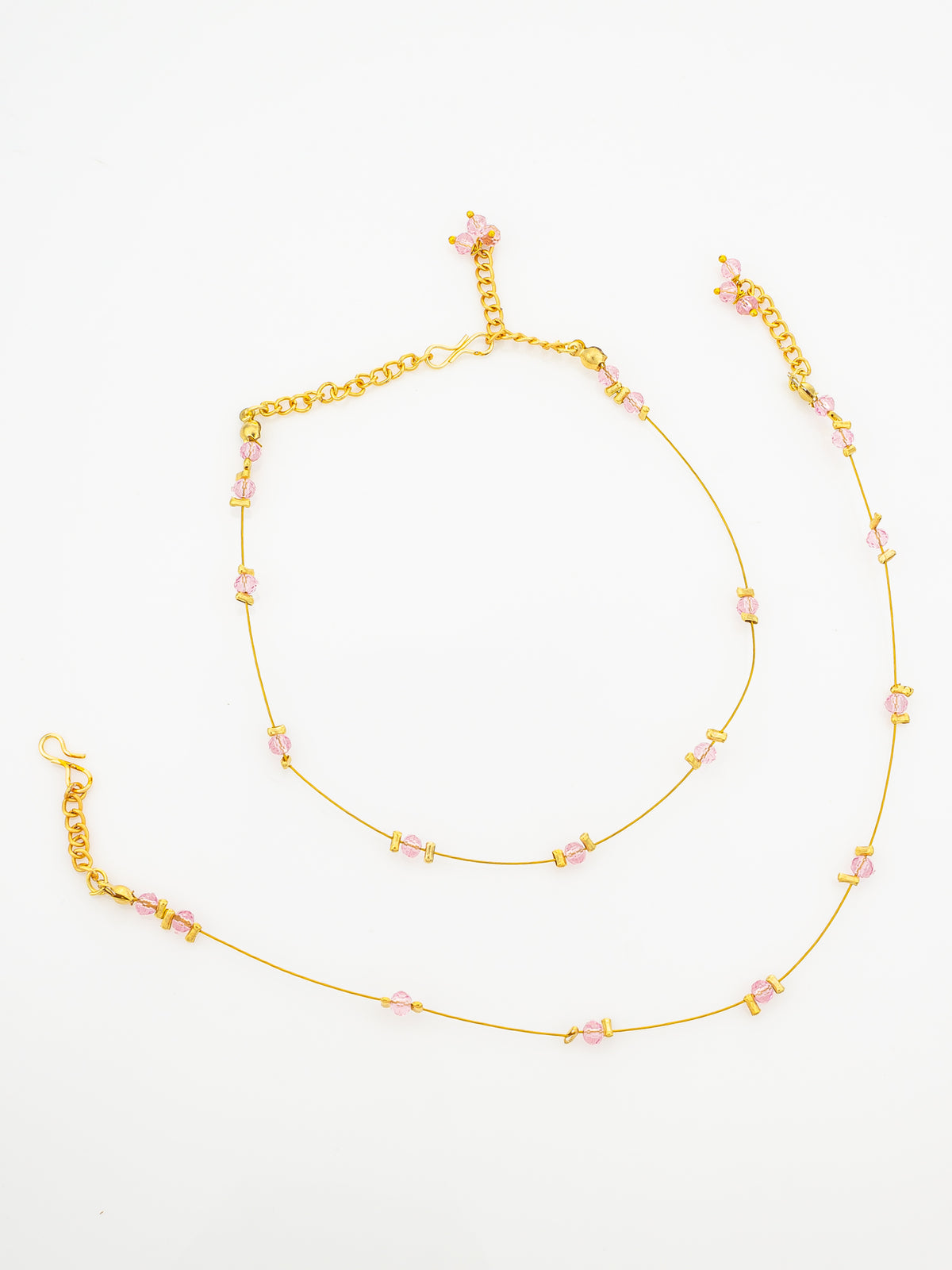 A delicate gold chain anklet decorated with small pink beads and star-shaped accents, displayed on a clean white background.