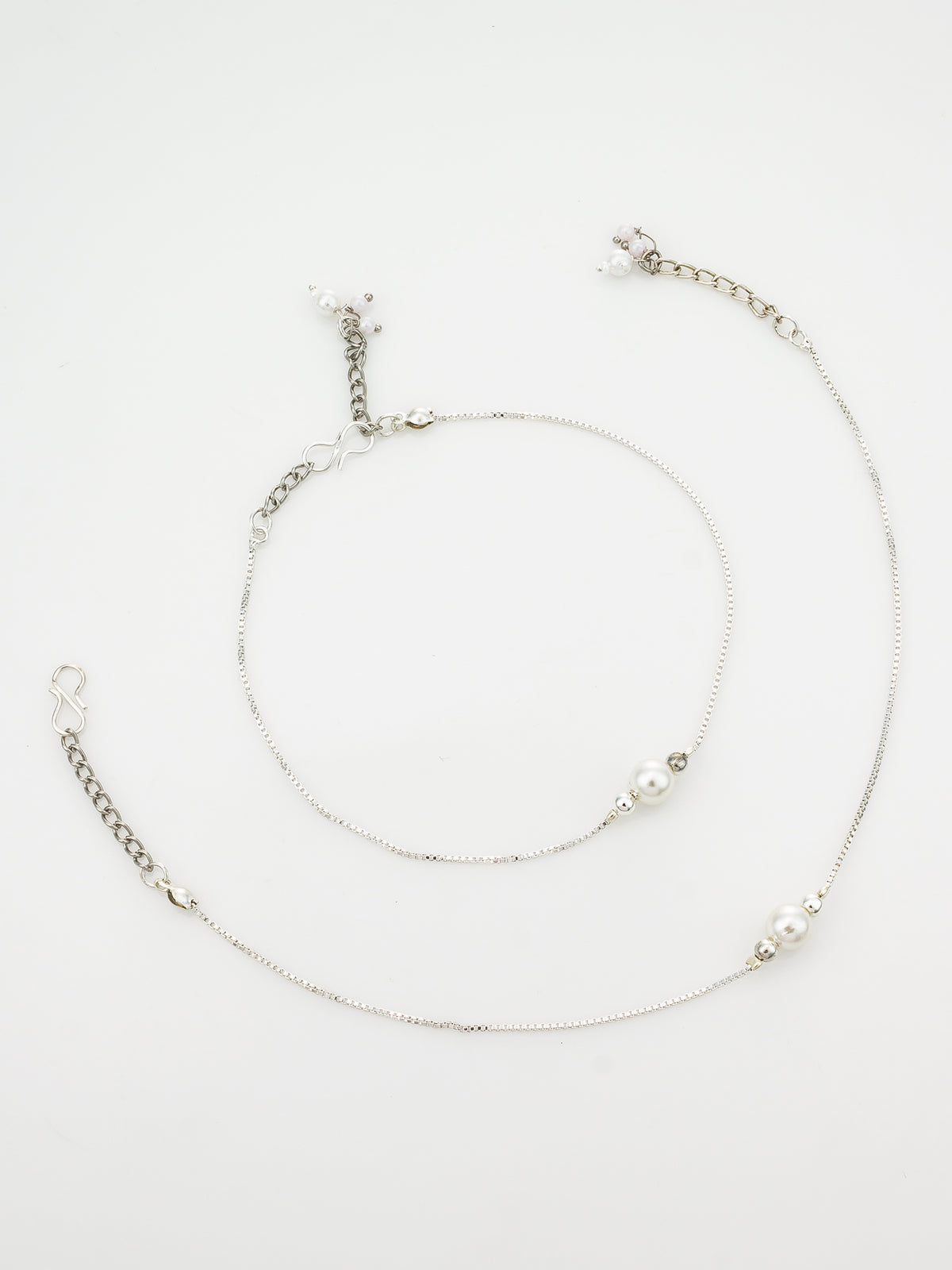 A delicate silver-toned chain anklet with small white pearl beads and tiny clear crystal accents, displayed on a clean white background.