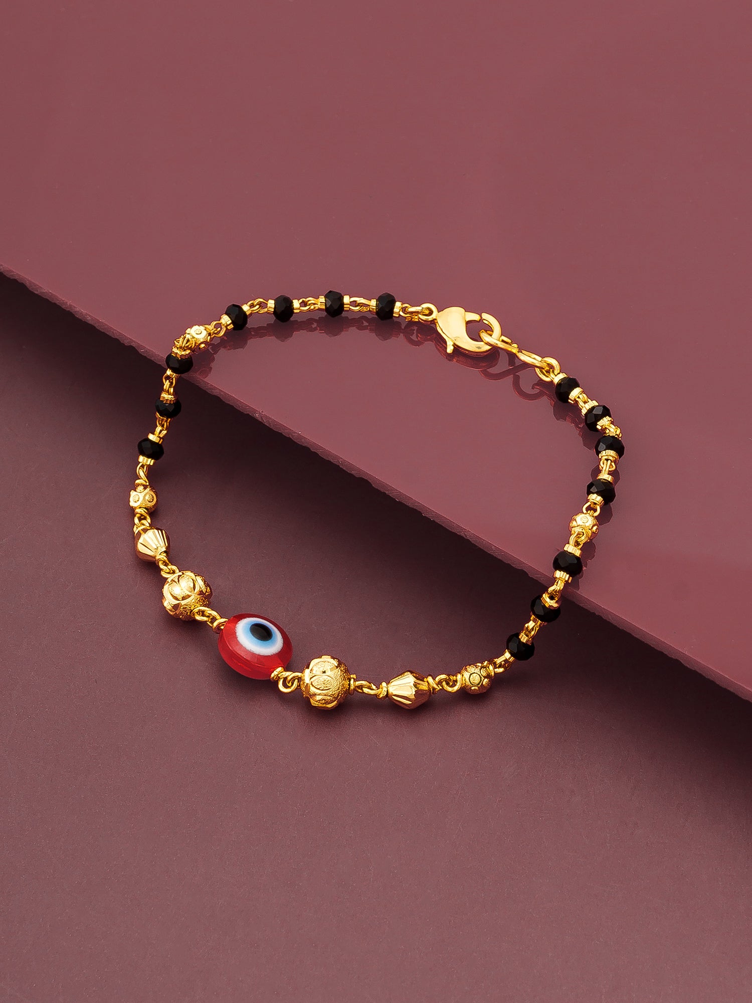 Aadita Gold Plated Black Bead Red Evil Eye Bracelet