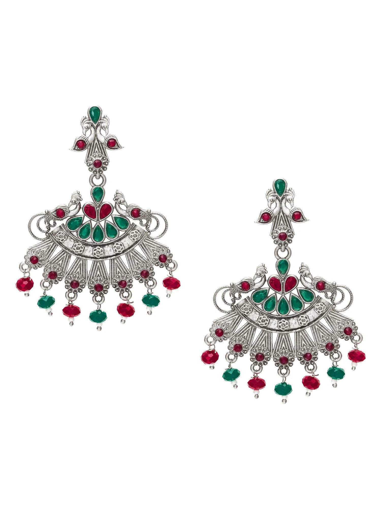 A pair of ornate silver-toned Indian jhumka earrings embellished with green and red stones, shown on a plain white background.