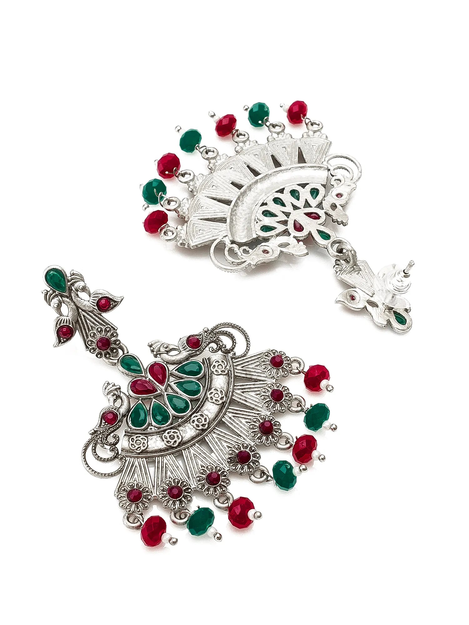 A pair of silver-toned traditional Indian jhumka earrings embellished with red and green stones, displayed on a clean white background.