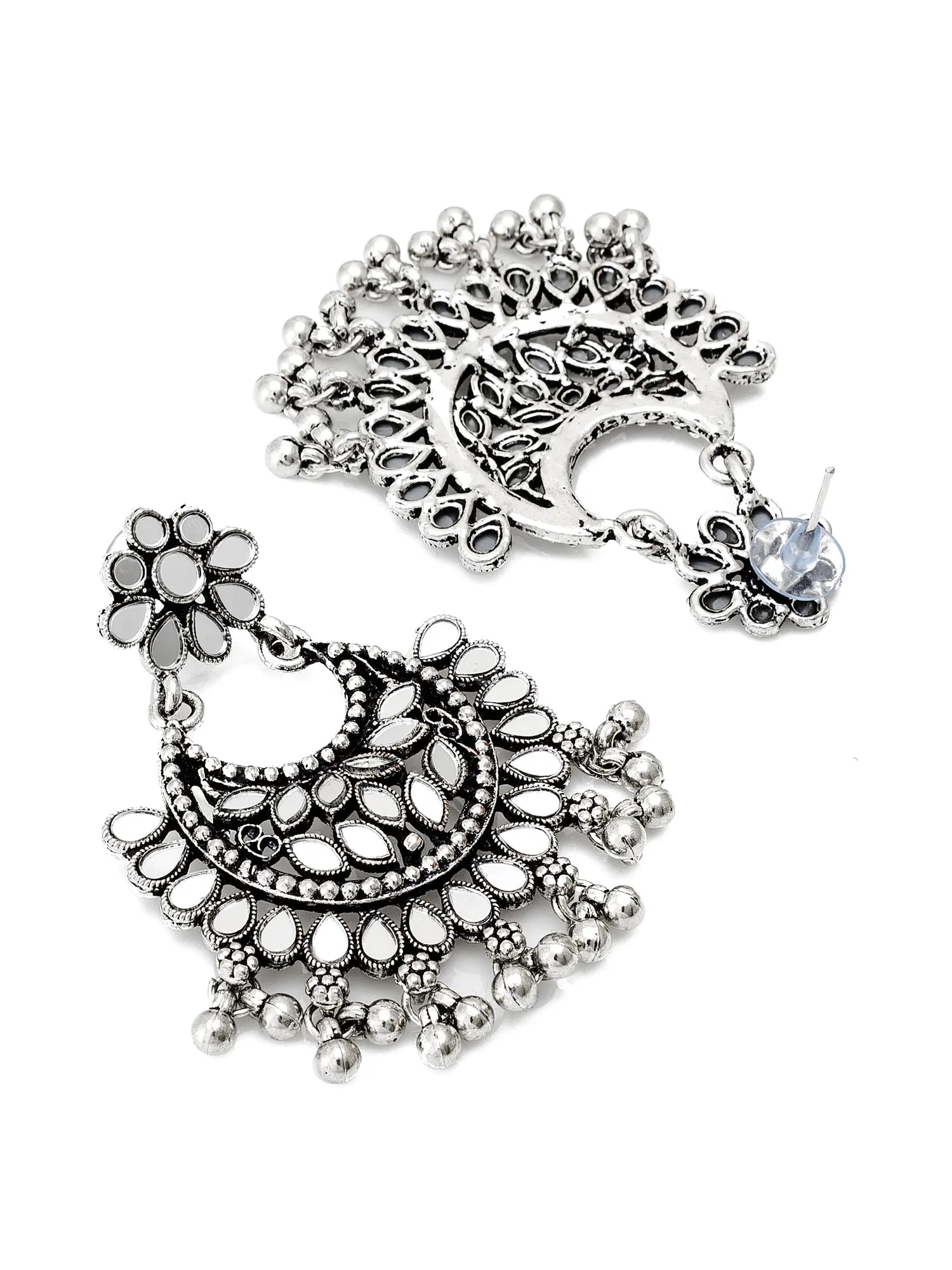 A pair of silver-toned traditional Indian jhumka earrings with intricate filigree work, floral motifs, and dangling bead details, shown on a plain white background.