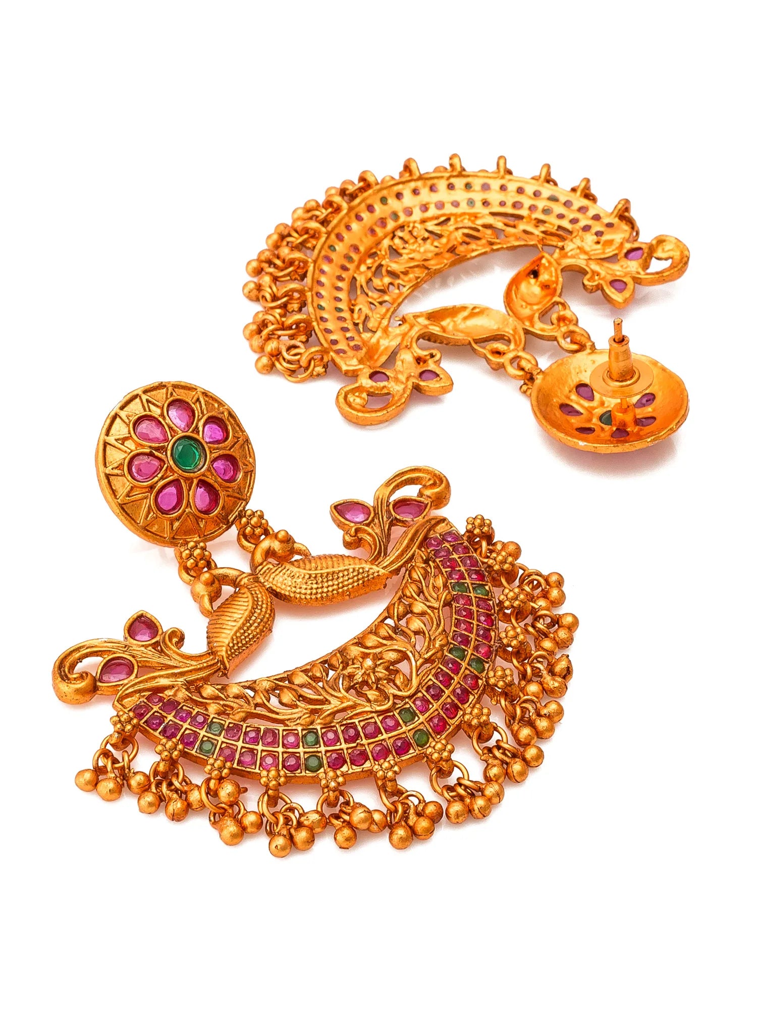 A pair of ornate gold-toned Indian chandbali earrings decorated with pink and red stones, green accents, and dangling bell charms, shown on a plain white background.