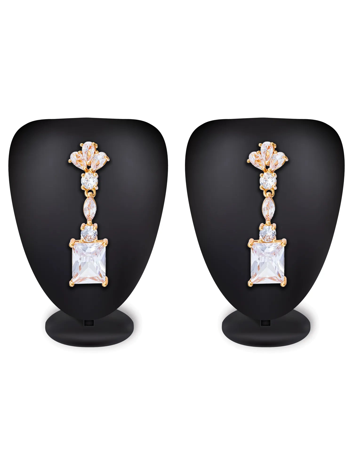Pair of diamond earrings on black stands against a white background