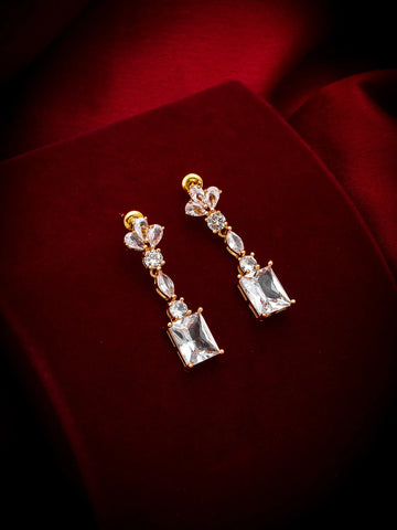 Pair of diamond earrings on a red fabric background