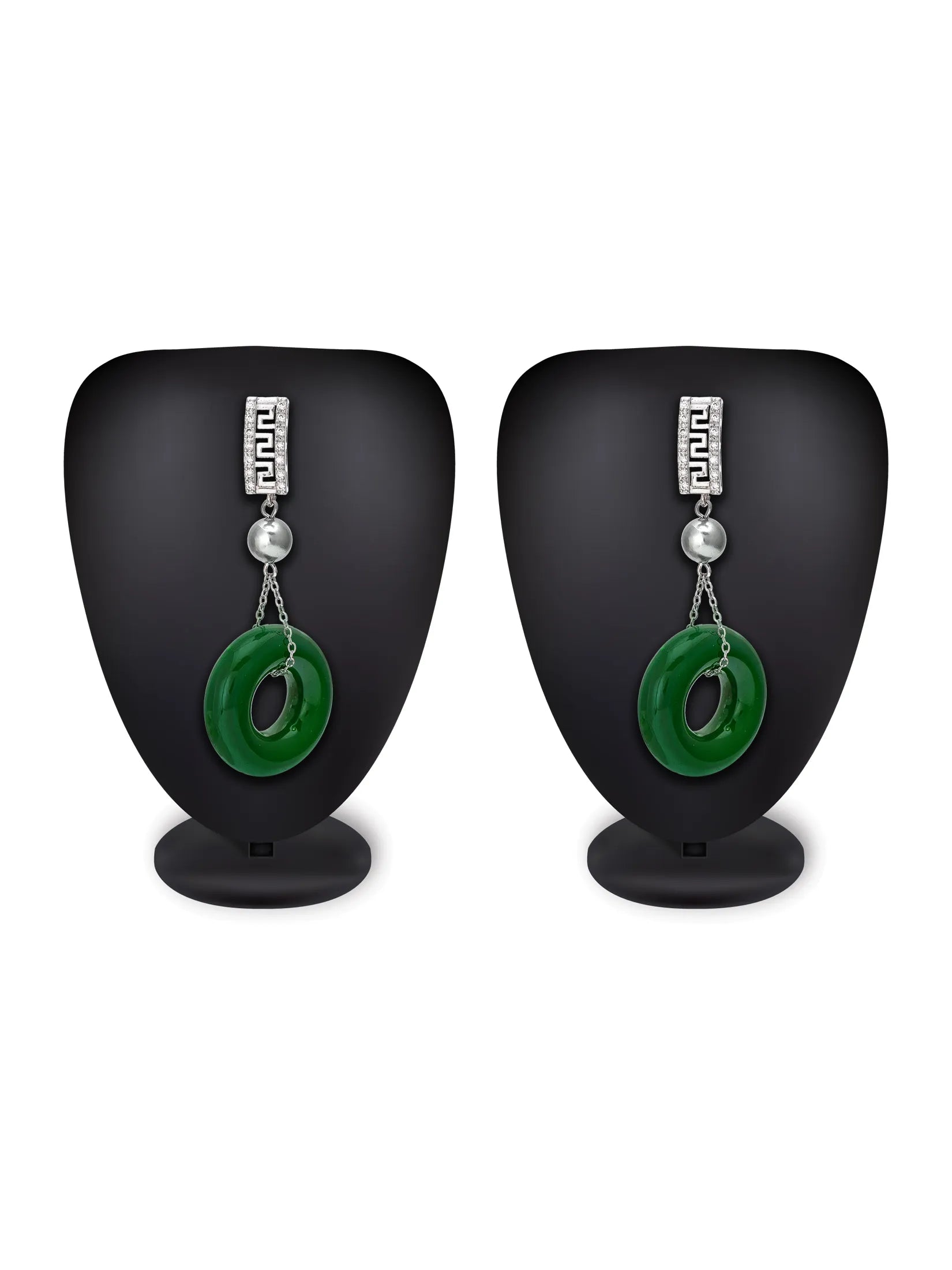 A pair of silver drop earrings with a rectangular silver top, a small white bead, and a green circular ring dangle, displayed on black mannequin stands against a white background.