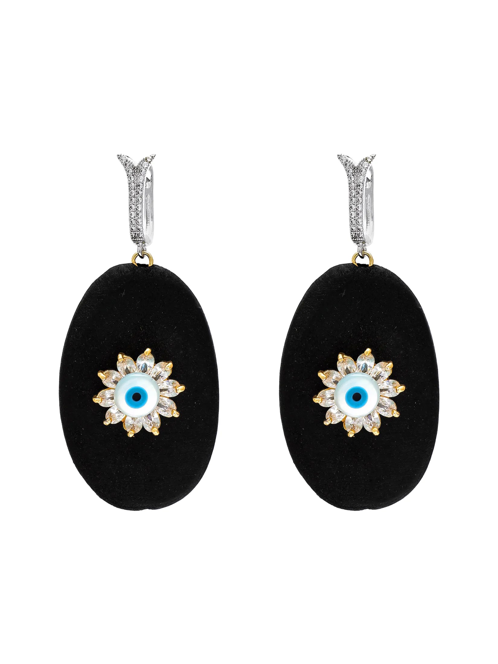 A pair of drop earrings featuring large black oval pendants with a gold and crystal evil eye flower design in the center, suspended from silver huggie hooks with small crystal accents, set against a plain white background.