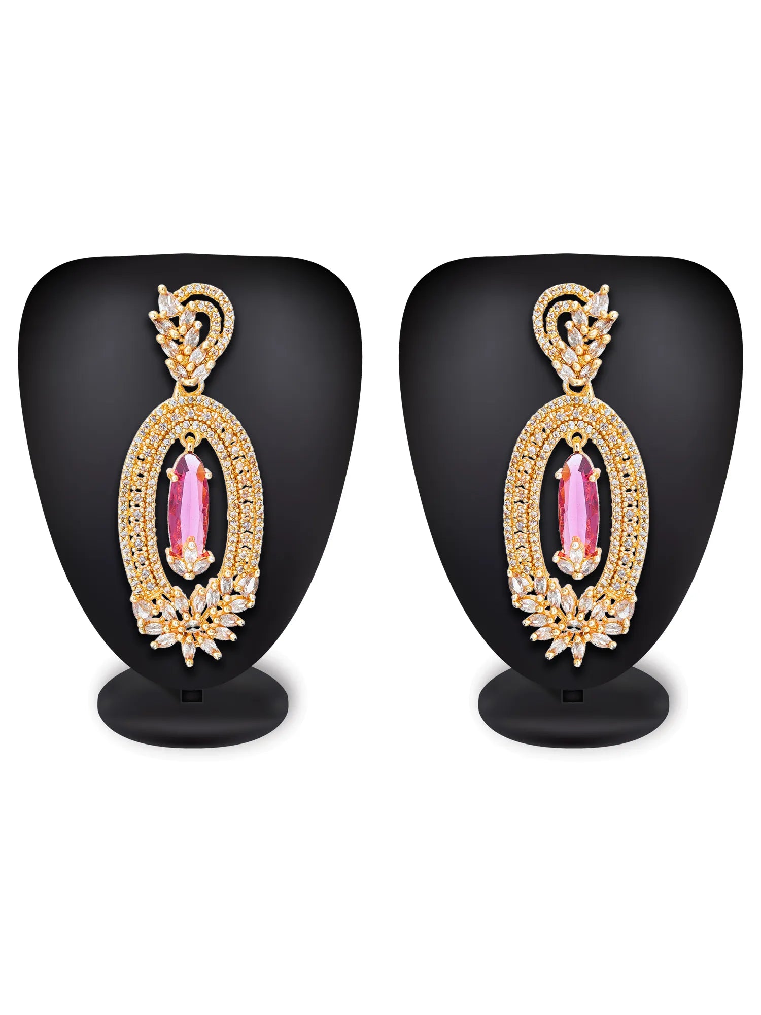 A pair of gold-toned statement earrings with large pink oval gemstones and clear crystal detailing, displayed on black mannequin busts against a white background.