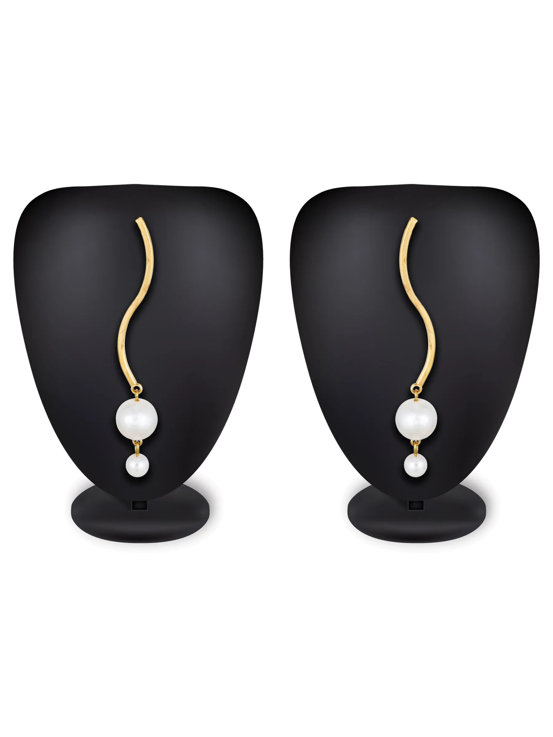 A pair of gold wavy drop earrings with white pearl-like beads, displayed on black jewelry busts against a white background.