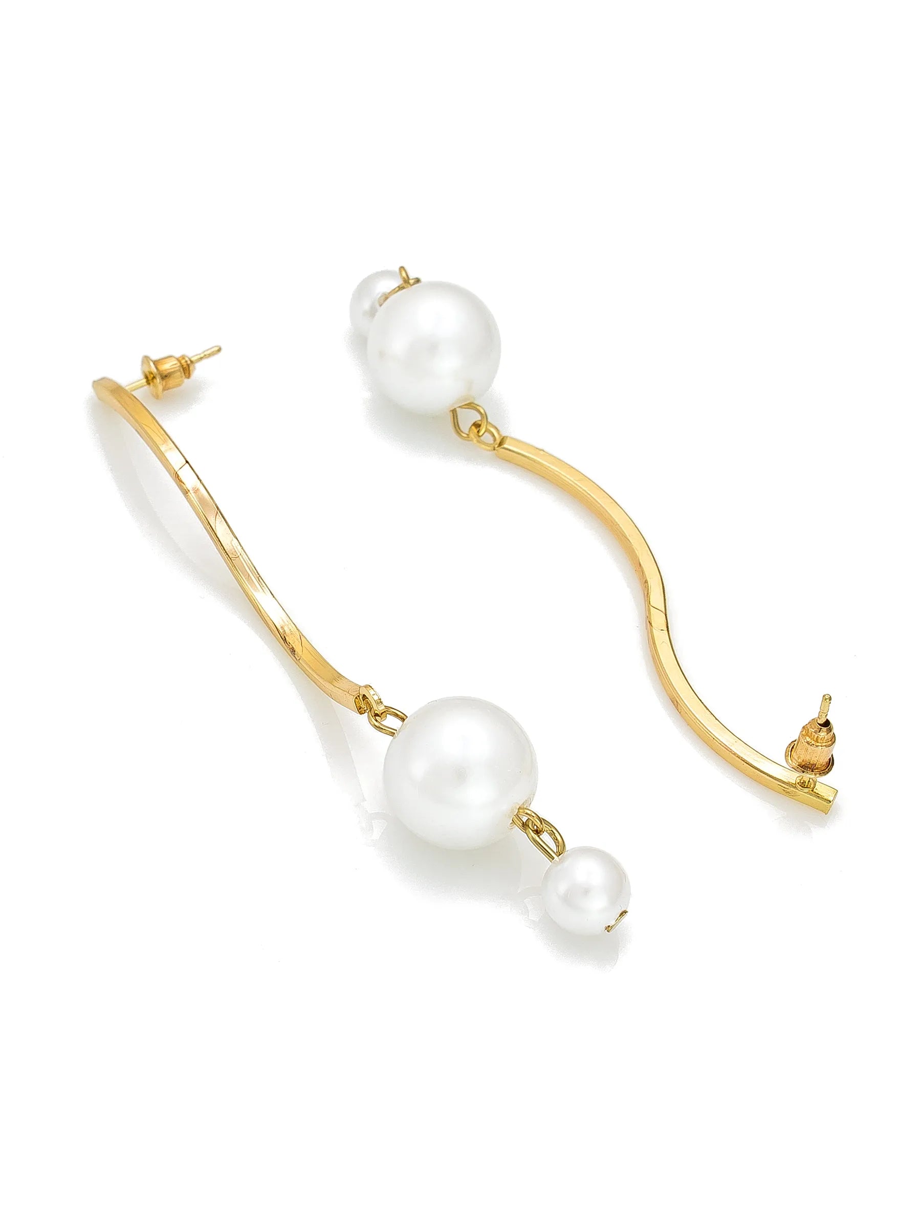Gold-tone dangle earrings with large white pearl-like beads and smaller pearl-like drops, photographed on a clean white background.