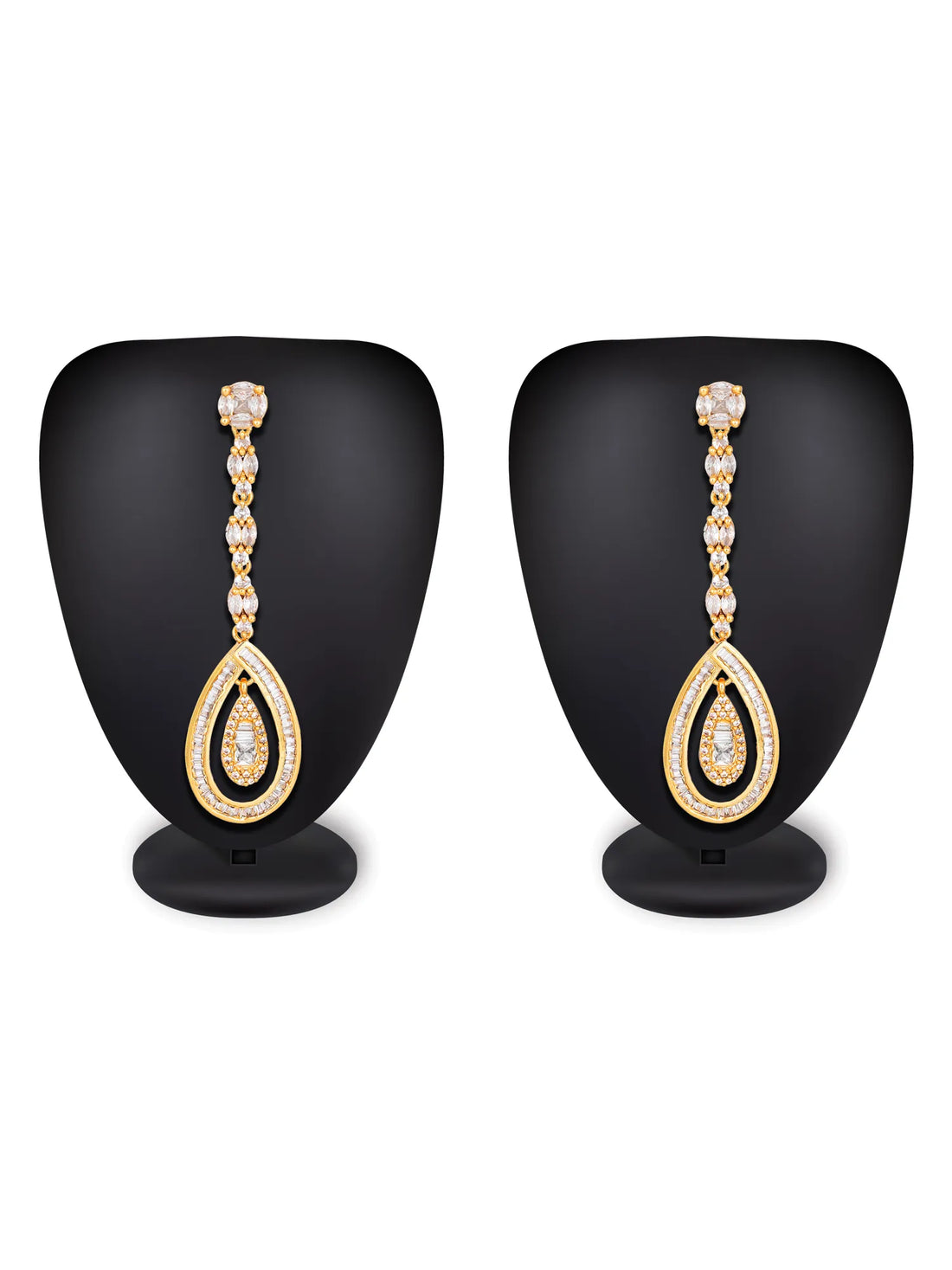 A pair of gold teardrop dangle earrings with clear rhinestone accents, displayed on a textured blue background.