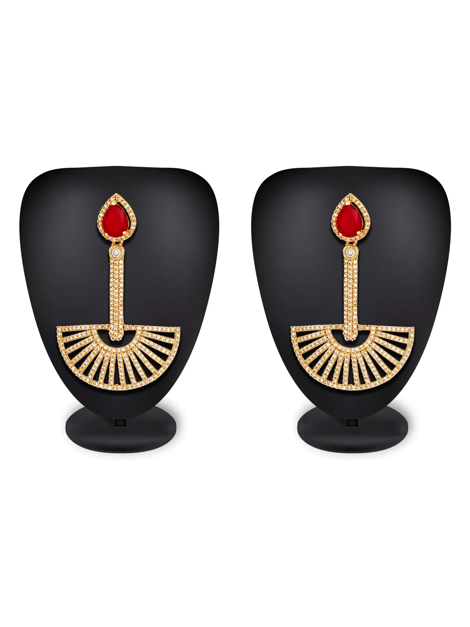 A pair of gold-toned traditional Indian earrings displayed on black mannequin busts against a white background. Each earring features a teardrop-shaped red stone at the top, a vertical gold stem paved with small clear stones, and a fan-shaped lower section with radiating gold details.