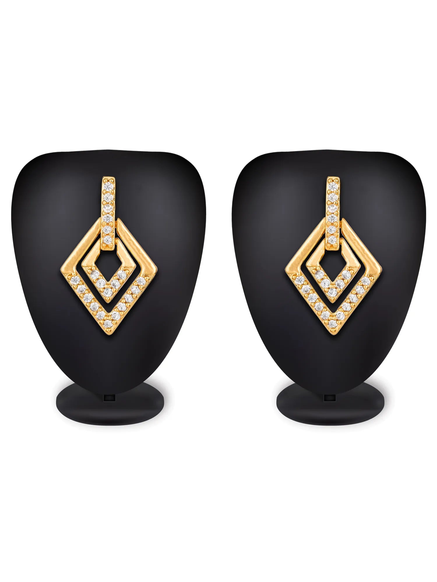A pair of gold geometric drop earrings with diamond-shaped nested frames, embellished with small clear stones, displayed on black mannequin busts against a white background.