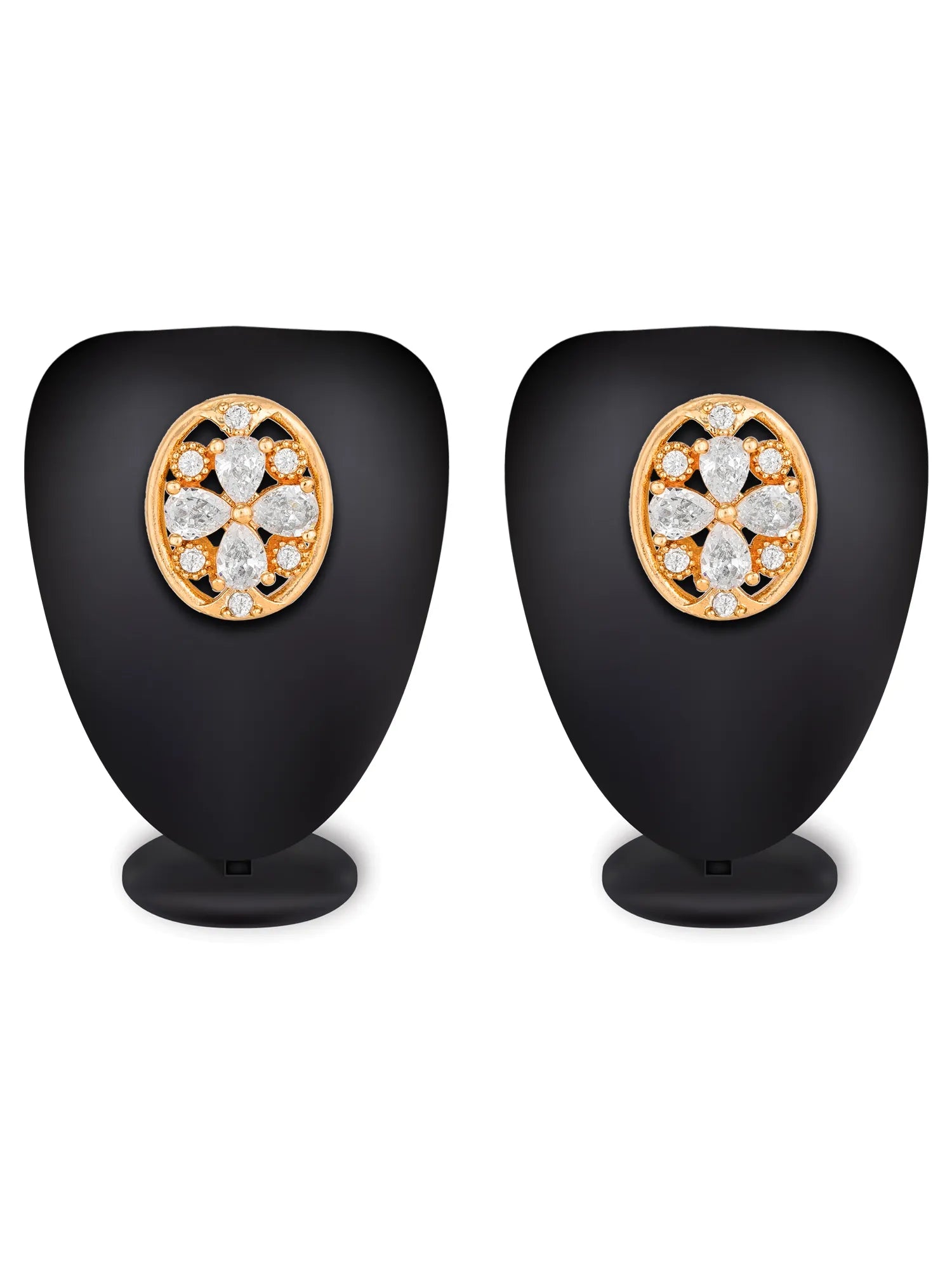 A pair of gold floral stud earrings displayed on black jewelry stands against a white background.