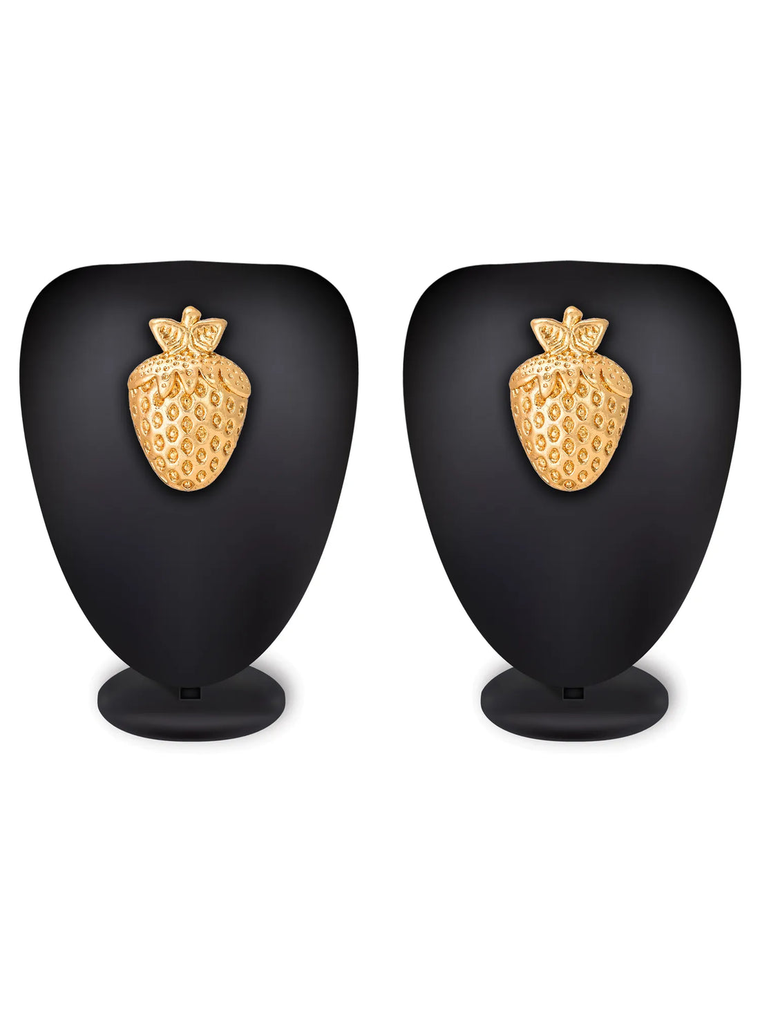 A pair of gold stud earrings shaped like textured strawberries, displayed on a dark red velvet surface with a matching red fabric backdrop.