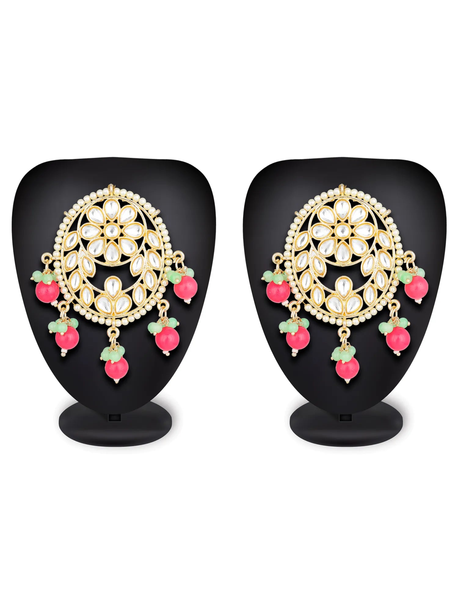Pair of ornate earrings with gold and pink details on black stands.