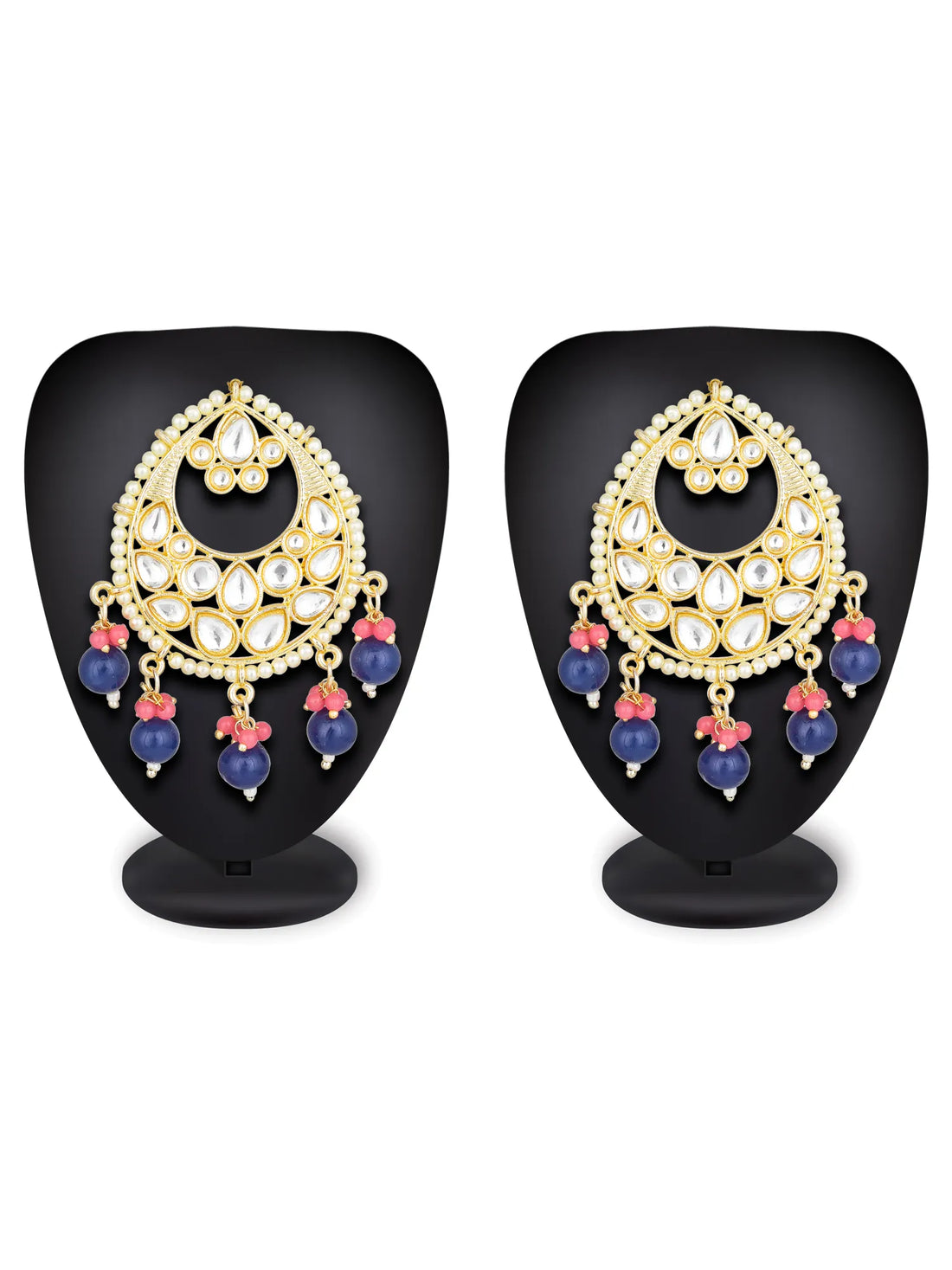 Ornate earrings with gold, blue, and red elements on a teal background