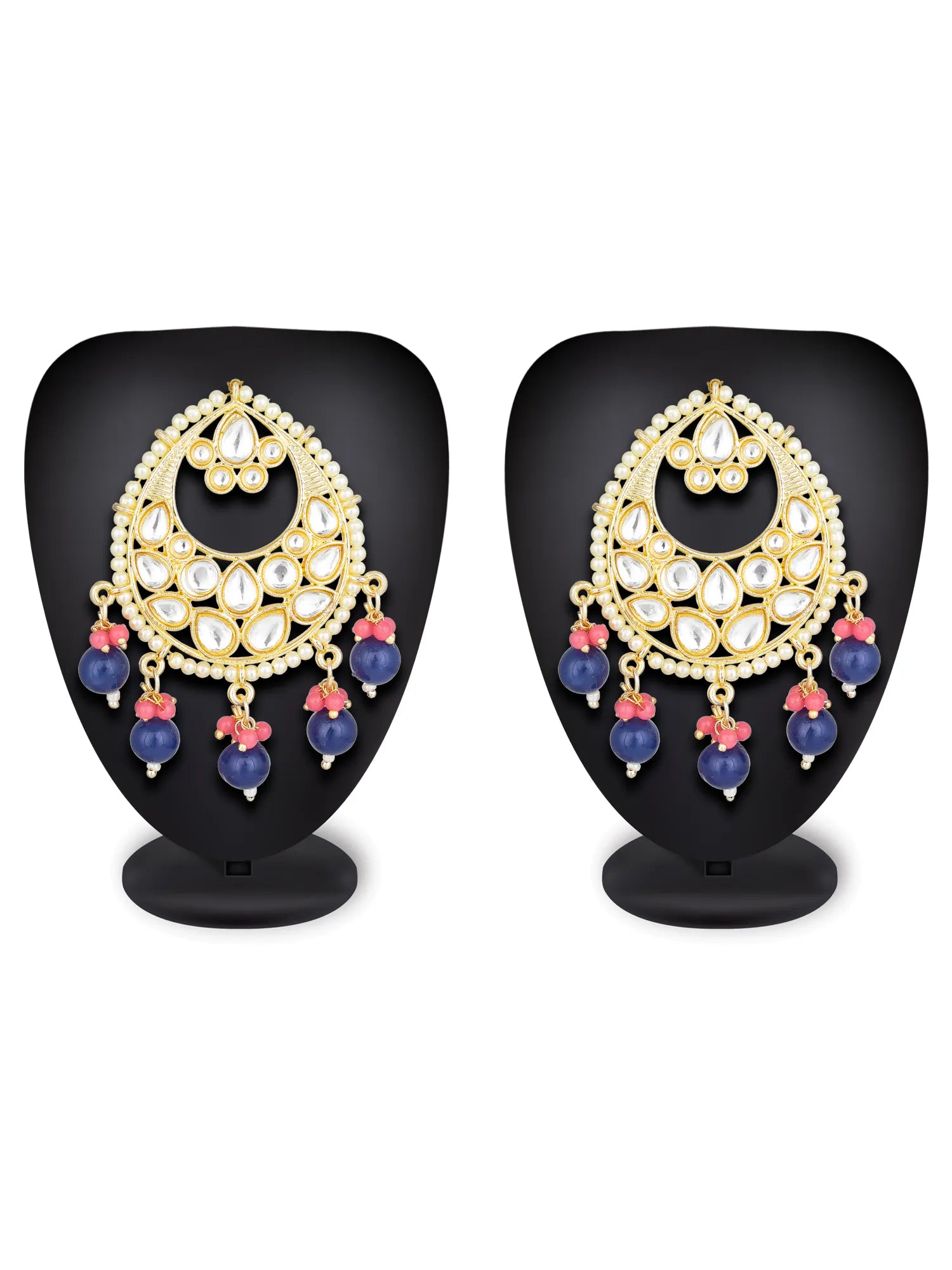 A pair of gold-toned traditional Indian Kundan earrings displayed on black mannequin stands against a white background. The earrings feature white stones, blue bead drops, and pink floral accents.