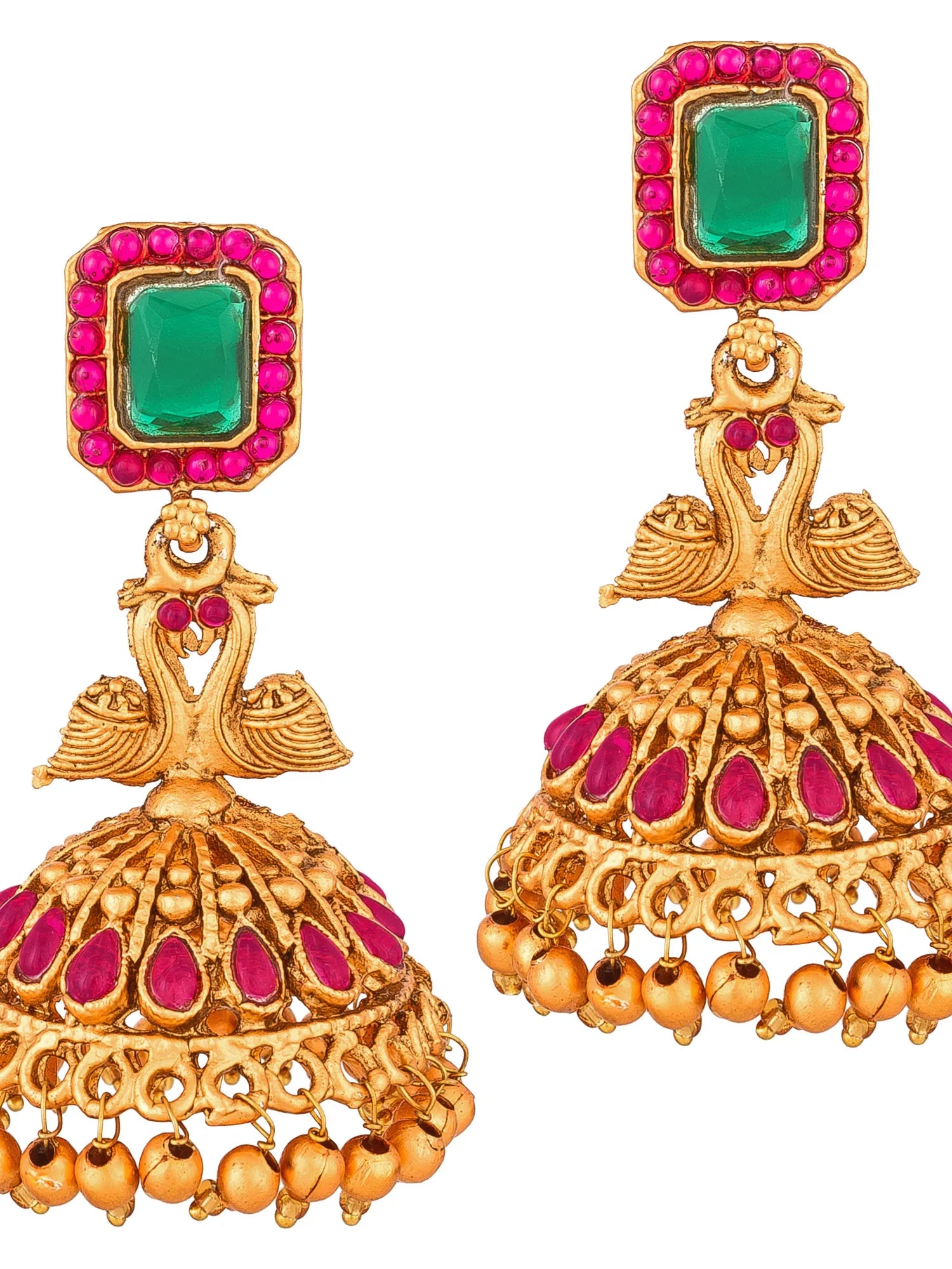 A pair of ornate gold-toned jhumka earrings with rectangular green stones bordered by bright pink stones, featuring swan motifs and dangling bell charms on a white background.
