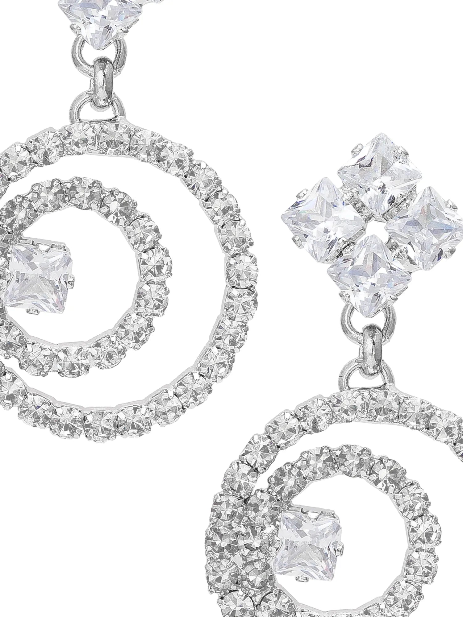 Silver earrings with circular designs and clear gemstones on a white background