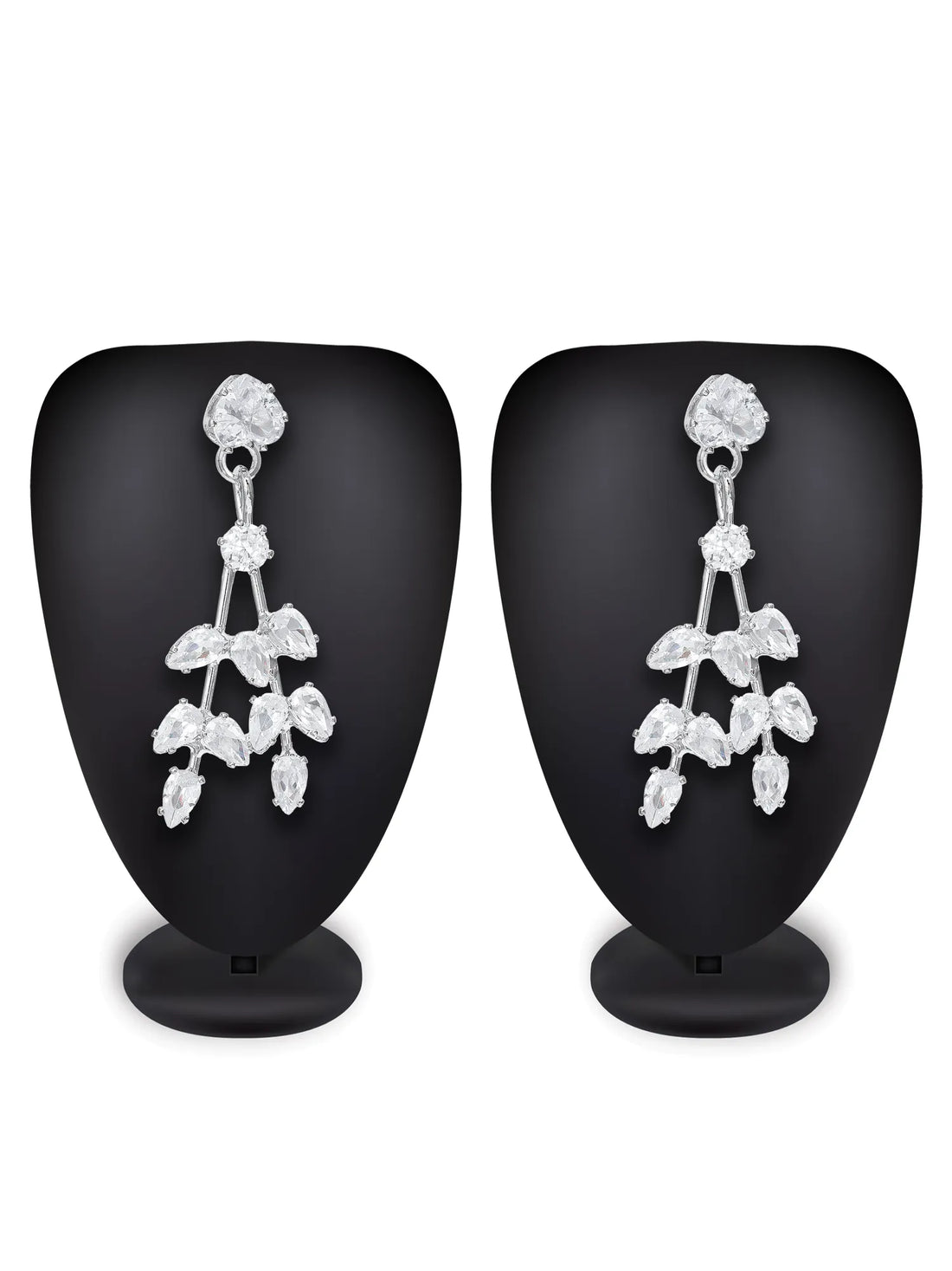 A pair of silver-toned dangle earrings with clear marquise-cut gemstones arranged in a leafy cluster design, displayed on a dark green textured background.