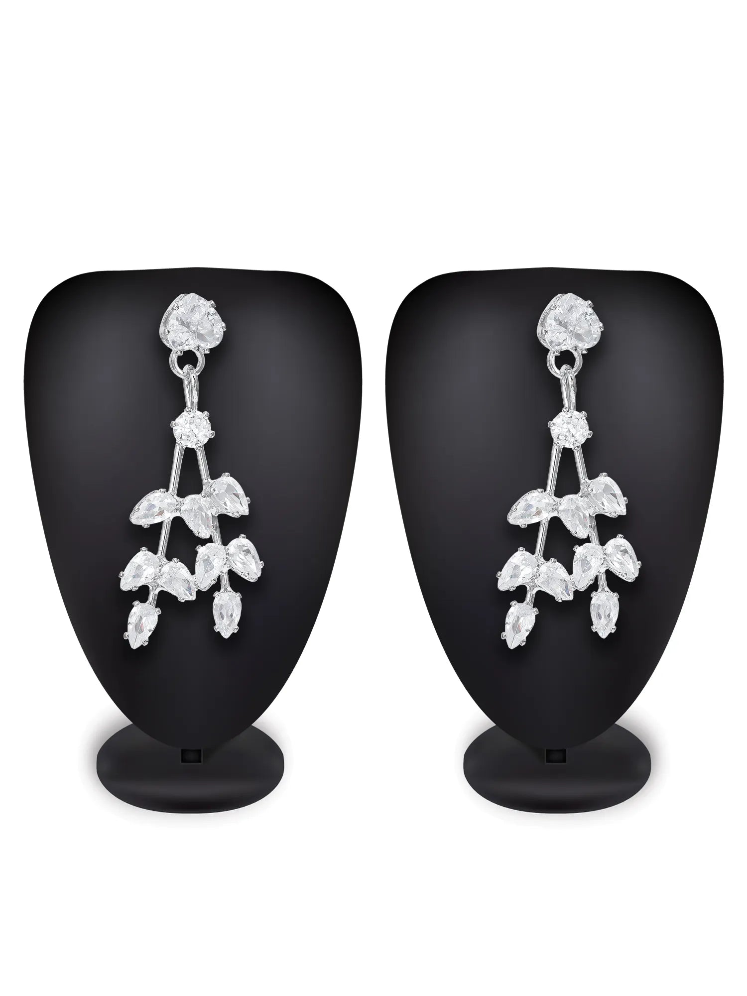 A pair of silver-toned dangle earrings with clear crystal floral and leaf motifs, displayed on black mannequin busts against a white background.