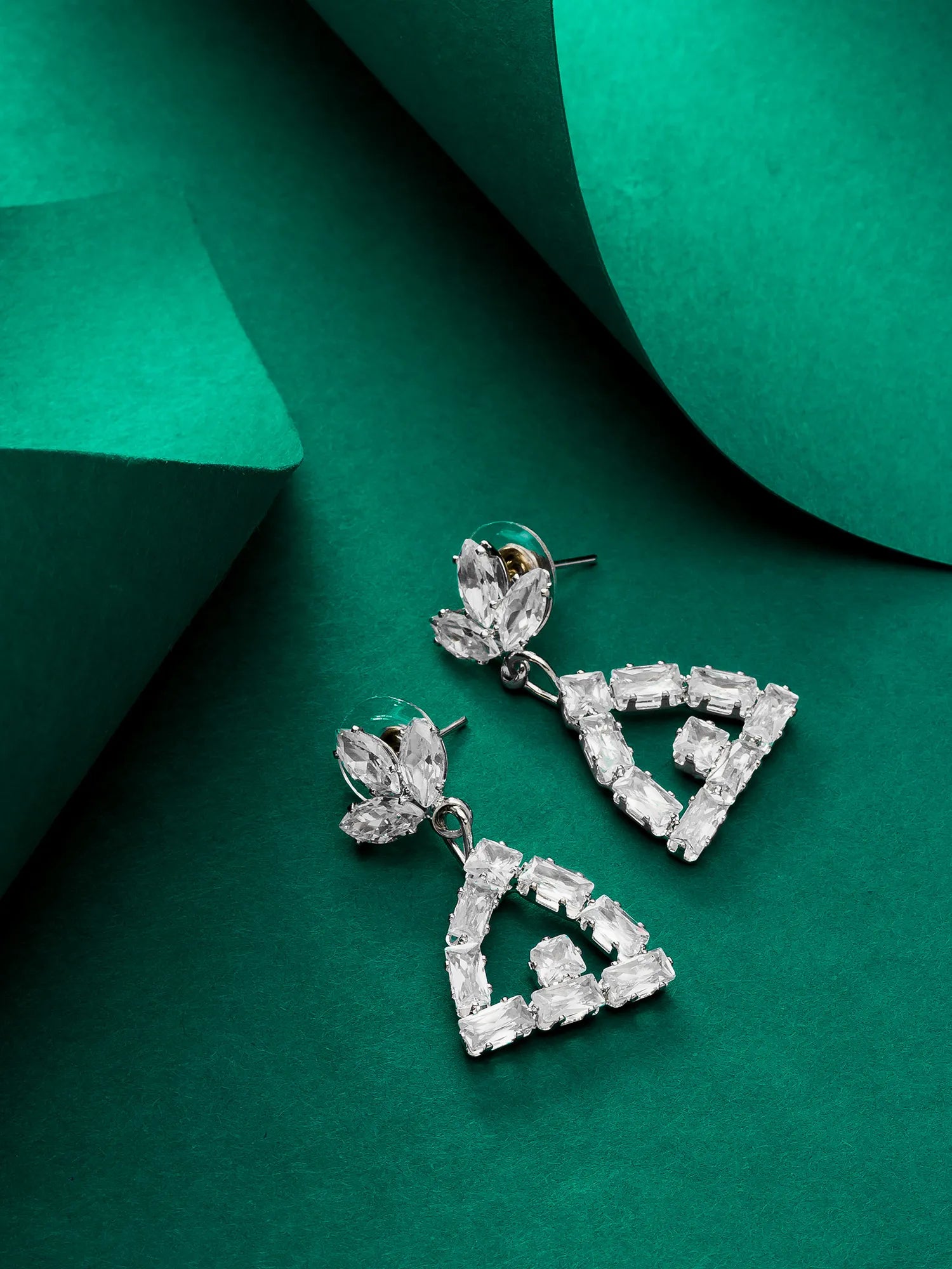Triangle Drop Earrings On a Background
