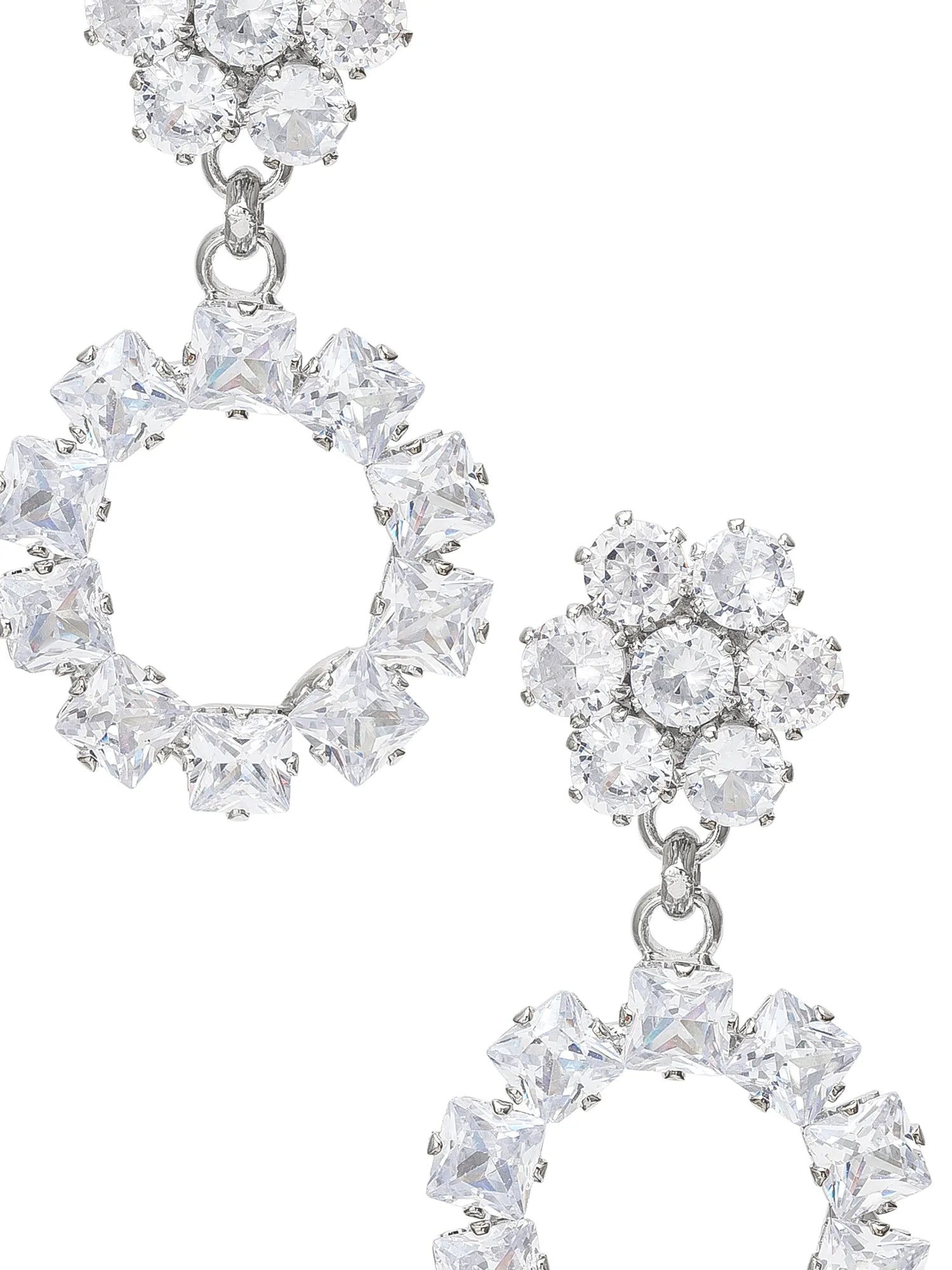 Pair of silver earrings with clear gemstones on a white background