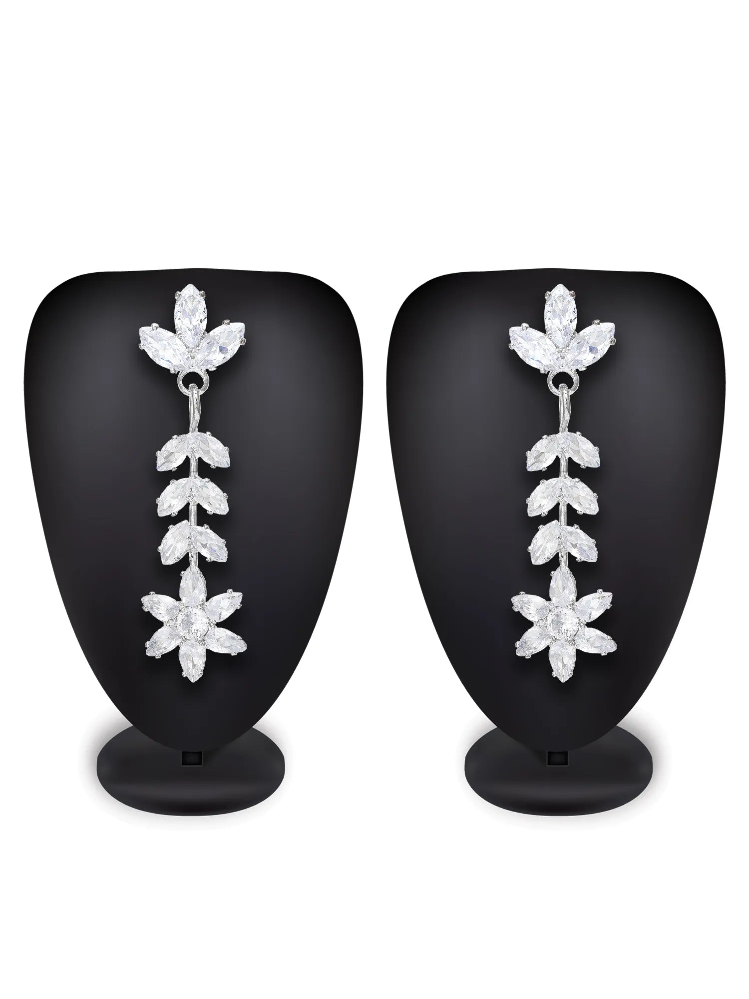 A pair of silver drop earrings with clear crystal floral and leaf designs, displayed on black mannequin busts against a white background.
