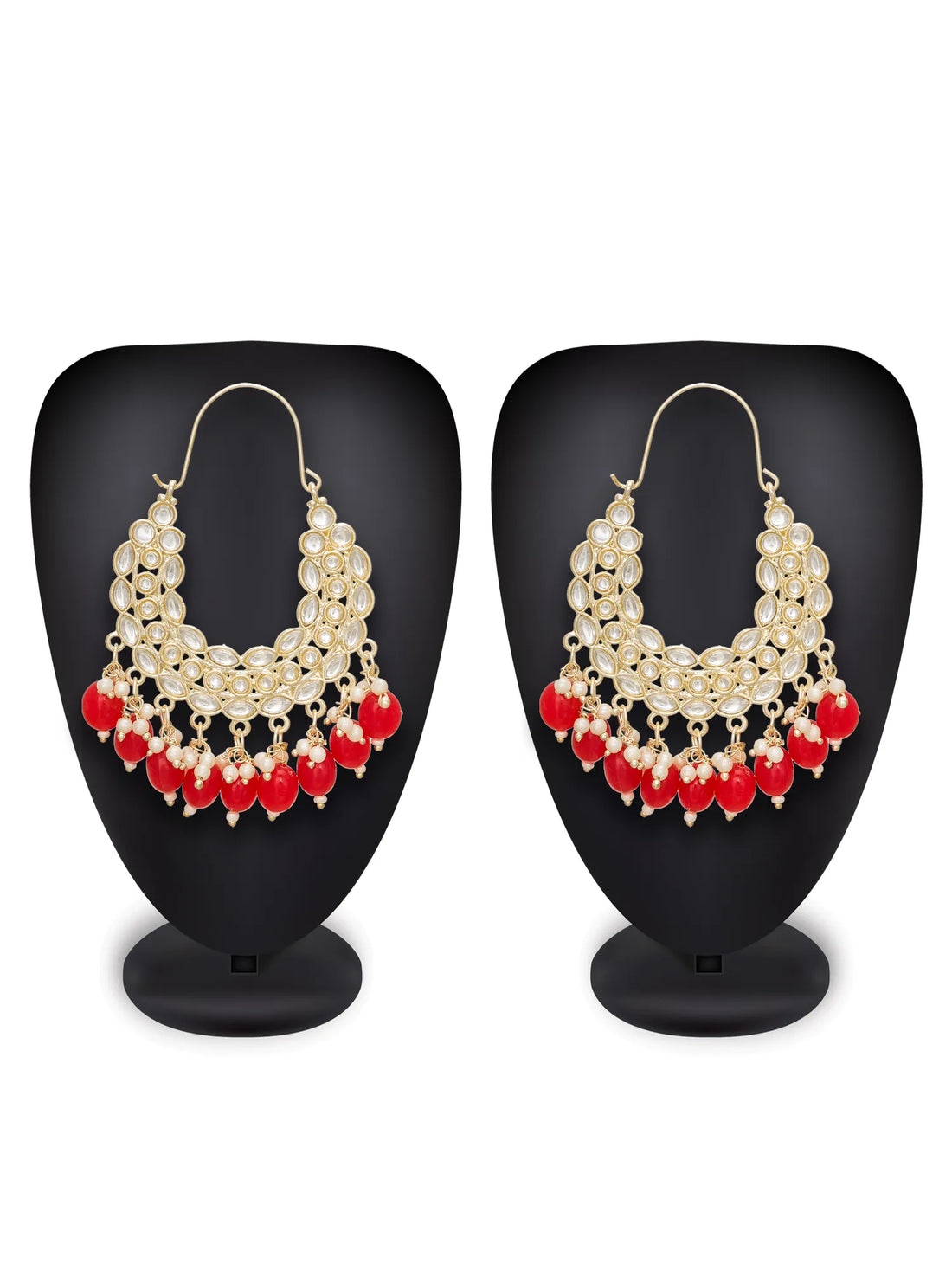 Pair of earrings with red beads and pearl-like stones on a pink background