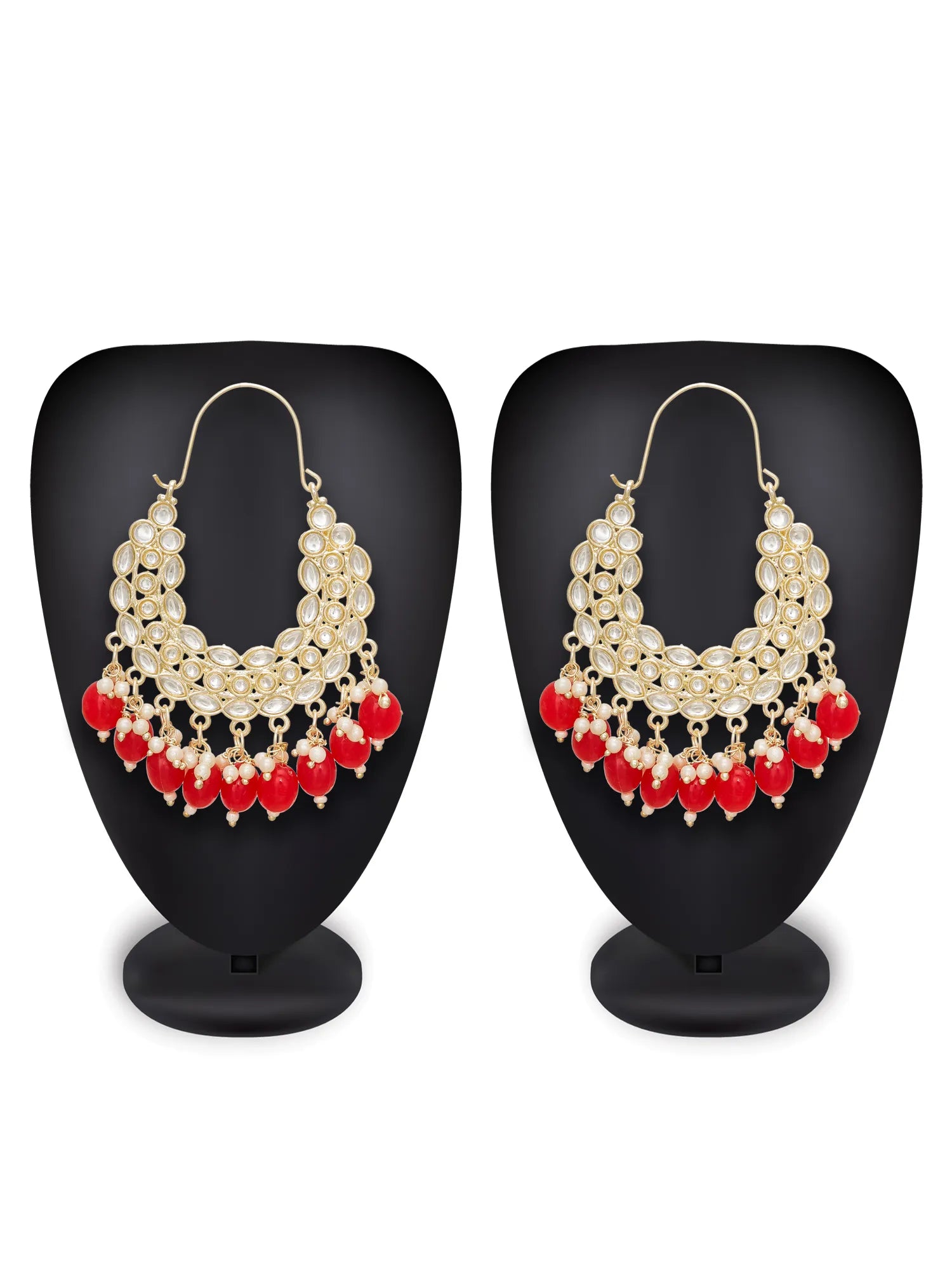 A pair of gold-toned statement earrings displayed on black mannequin busts against a white background. The earrings feature a layered design with gold-toned circular elements, white pearl-like beads, and dangling red bead drops.