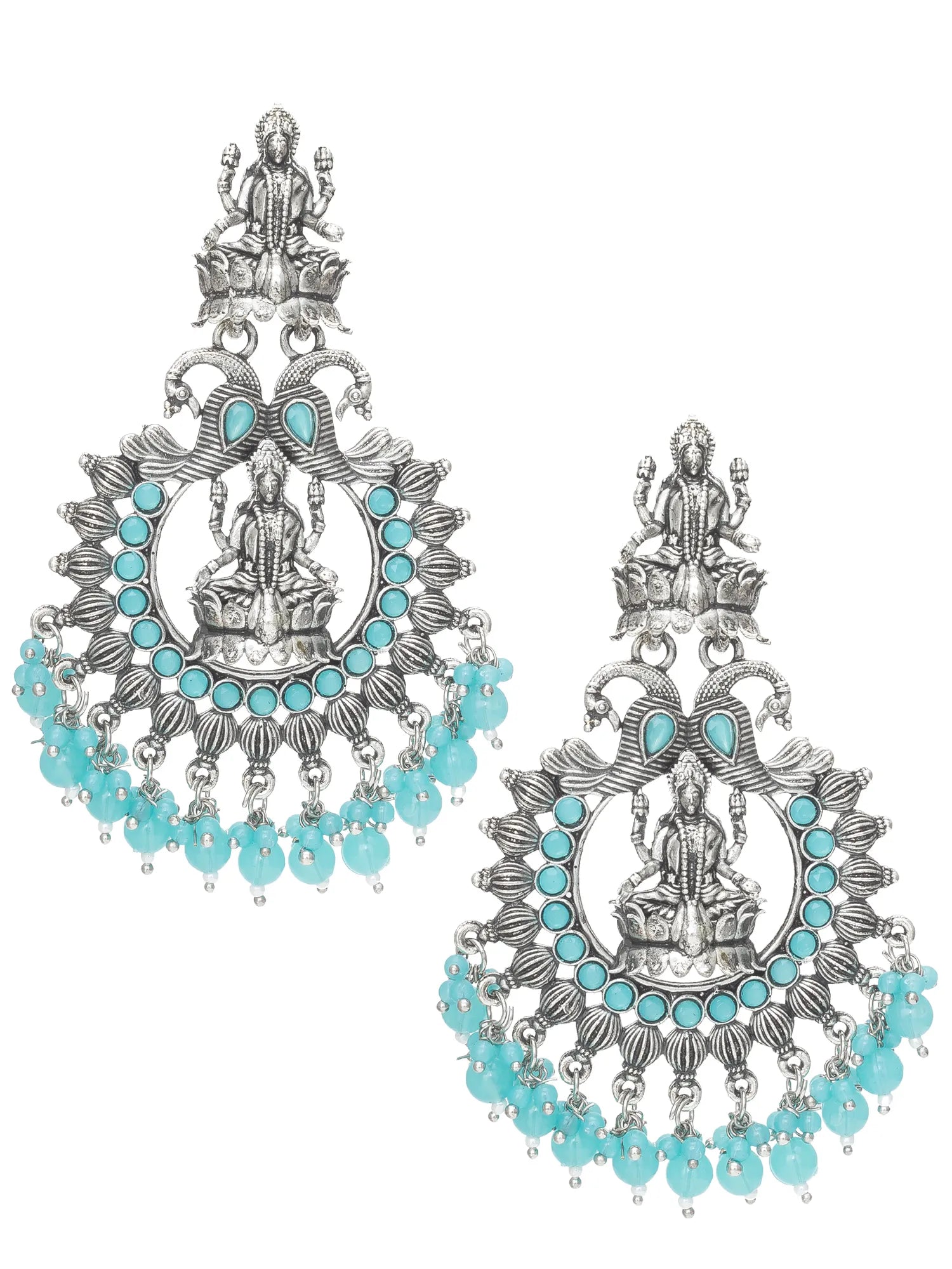 A pair of ornate silver-toned dangle earrings featuring detailed religious motifs, small turquoise blue stones, and hanging turquoise bead drops, shown against a plain white background.