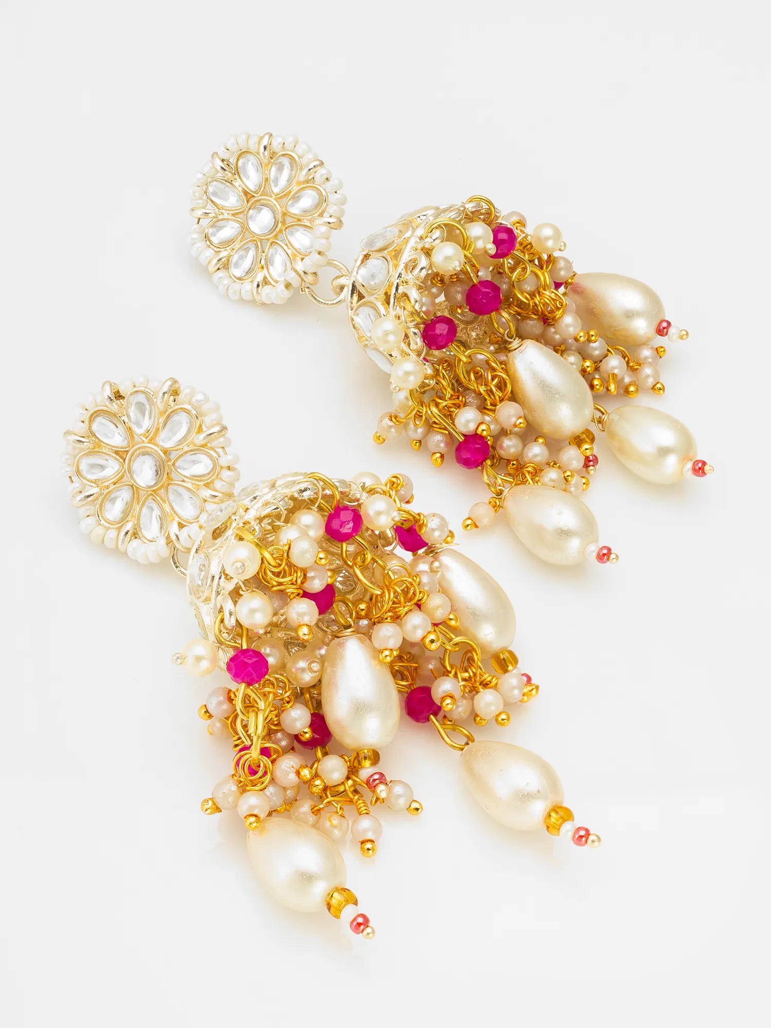A pair of ornate gold-toned statement earrings with white faux pearls, small pink gemstone accents, and bead details, displayed on a clean white background.