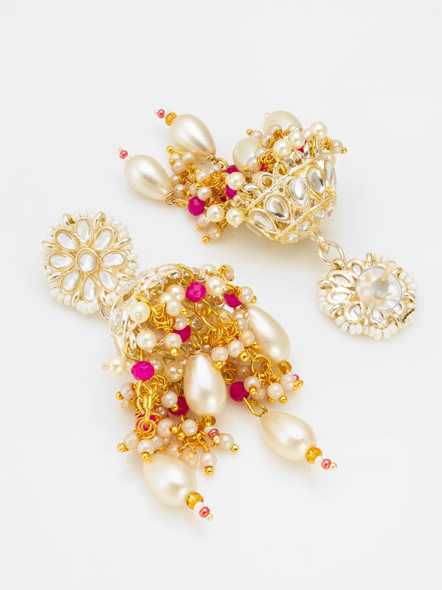 A pair of ornate gold-plated earrings decorated with white pearls, clear stones, and small pink gem accents, displayed on a clean white background.