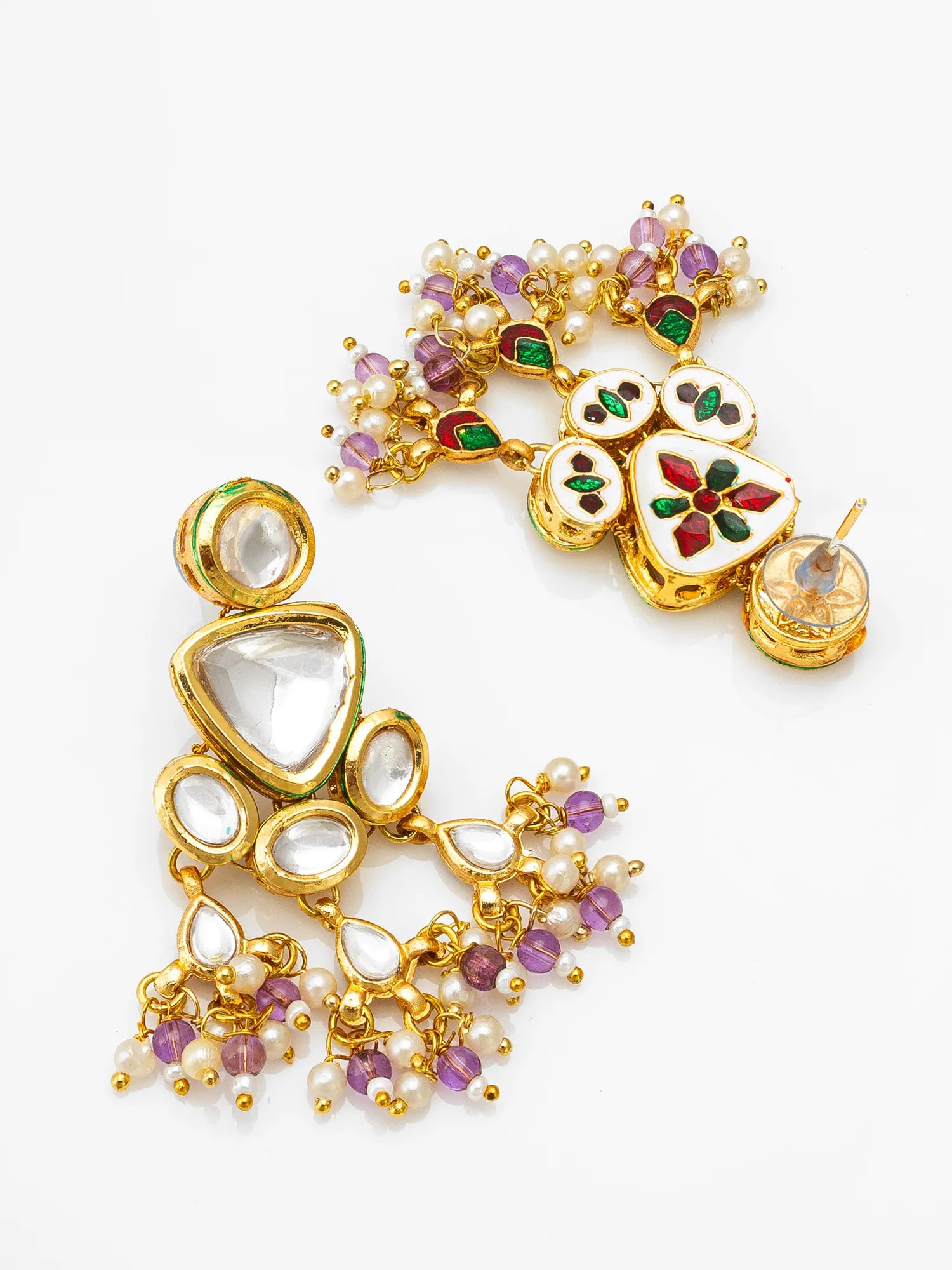A pair of ornate gold-plated statement earrings decorated with white pearls, clear crystals, and colorful enamel details in purple, green, and red on a white background.