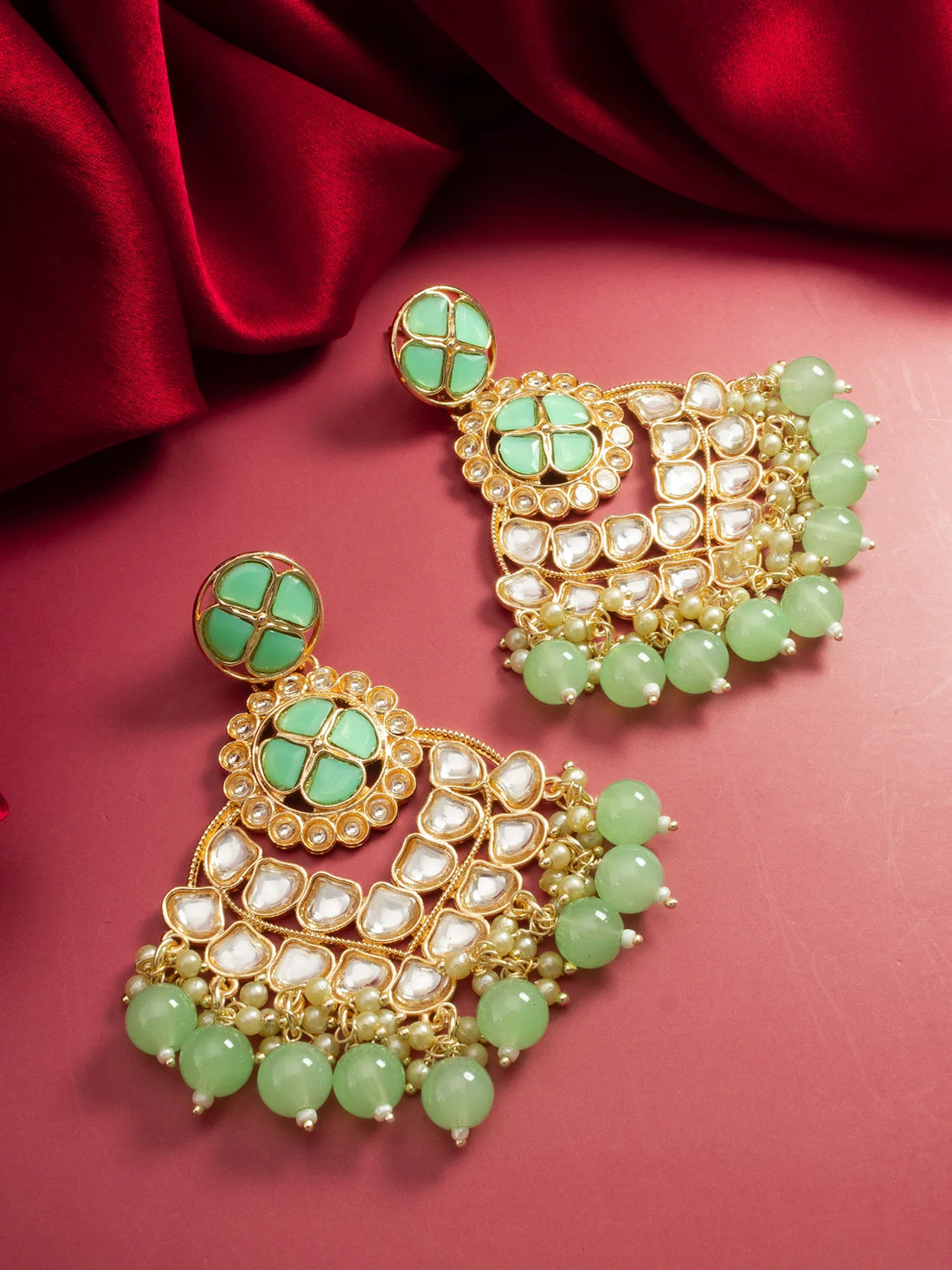 Kundan Chandbali Earrings On A Red Background