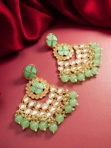 Kundan Chandbali Earrings On A Red Background