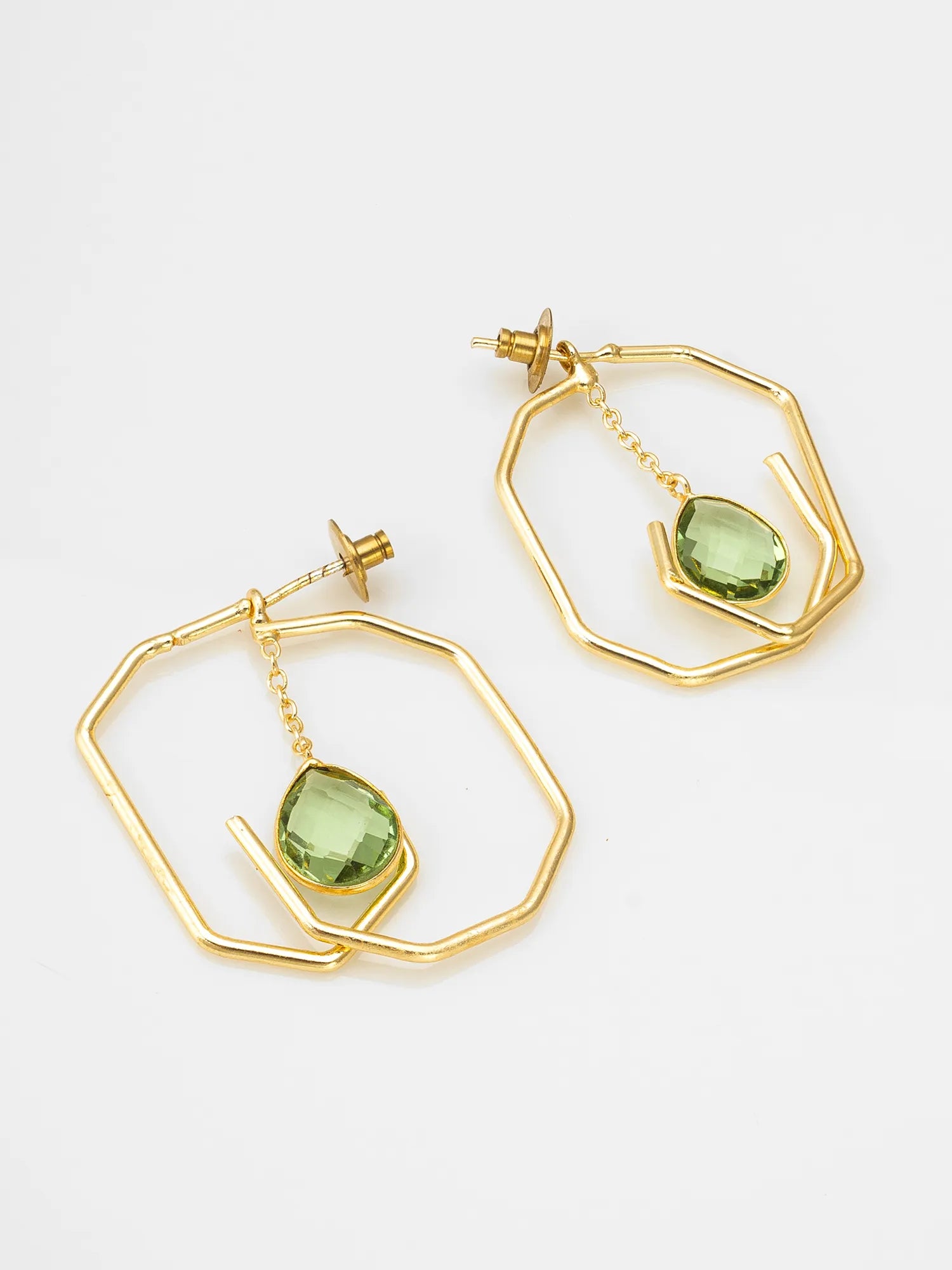 A pair of gold geometric dangle earrings with faceted green gemstone drops, displayed on a clean white background.