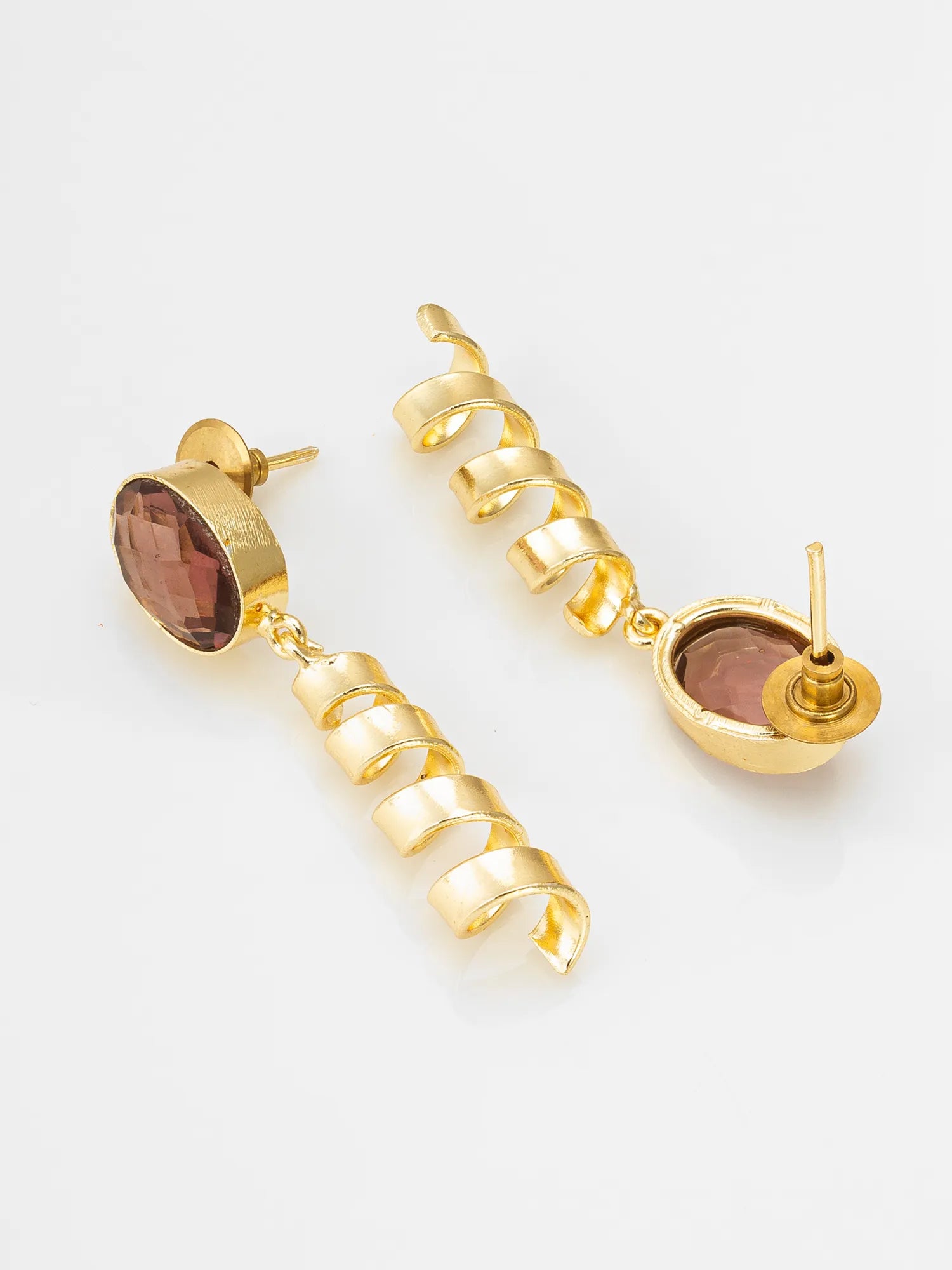 Gold earrings with brown gemstones on a white background